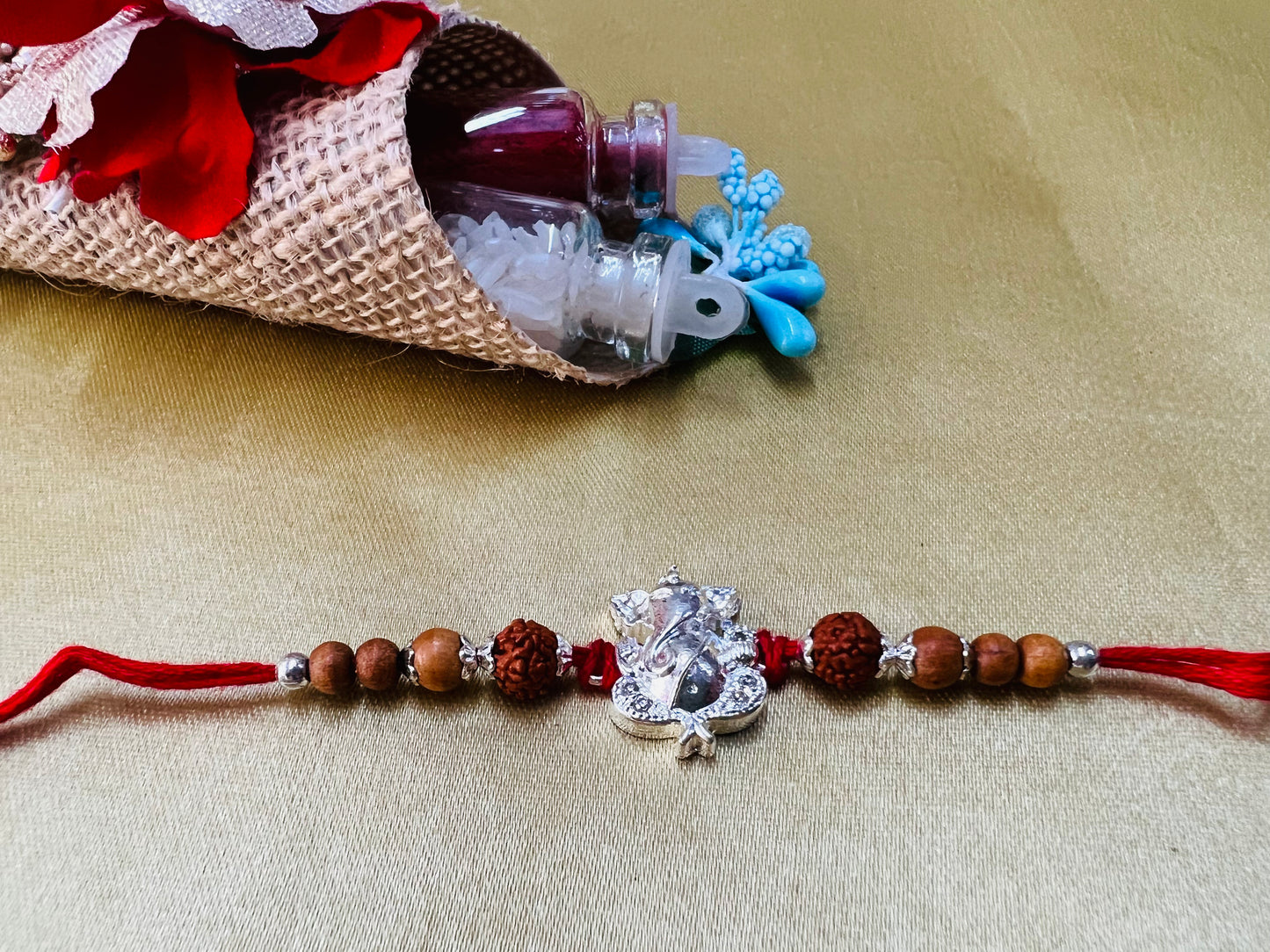 Wrap Shap Designer Rakhi with Silver Polished Ganesh, Beads, and Roli Chawal