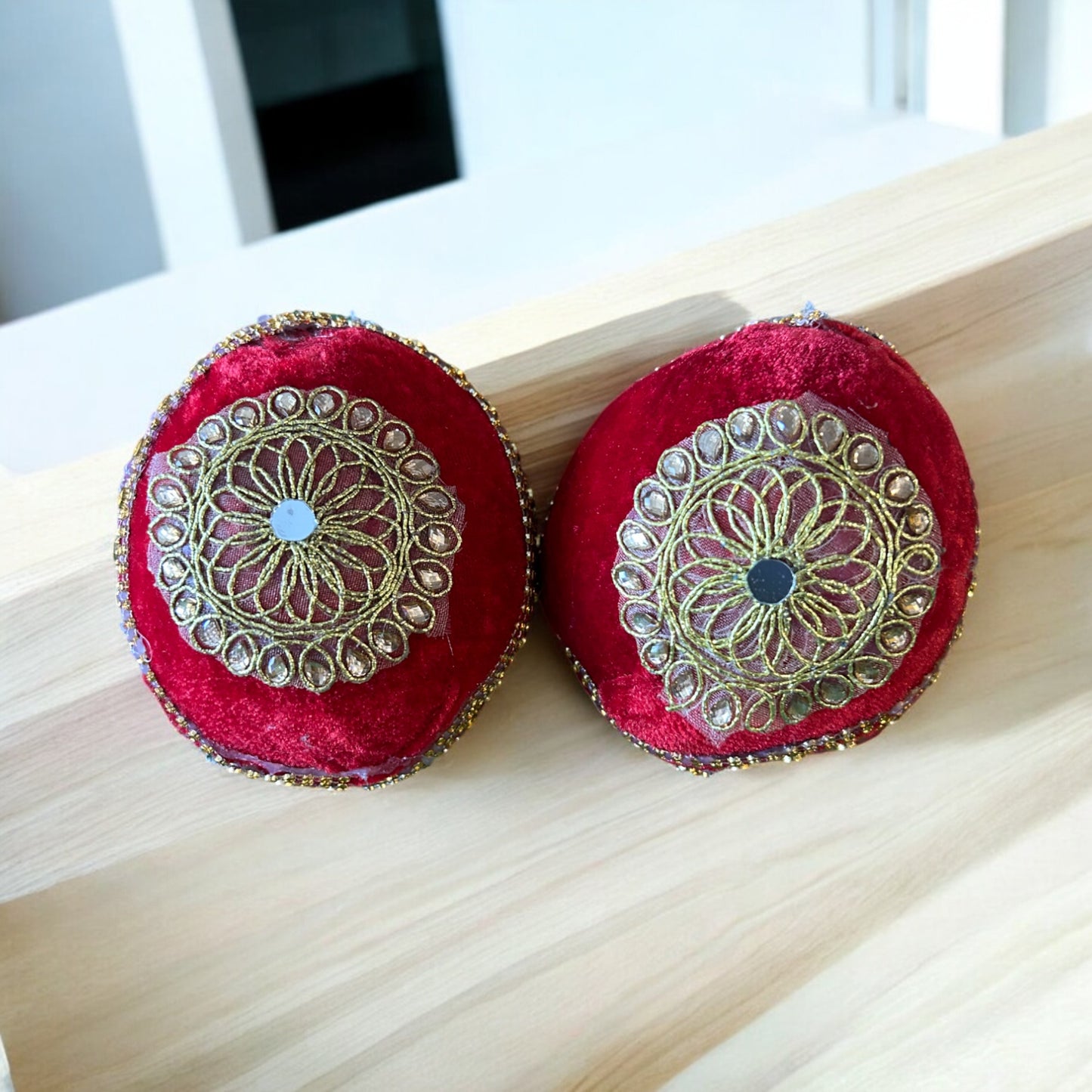 Decorated dry coconut wrapped in red cloth with unique golden booti design for pooja and shagun by Wrap Shap