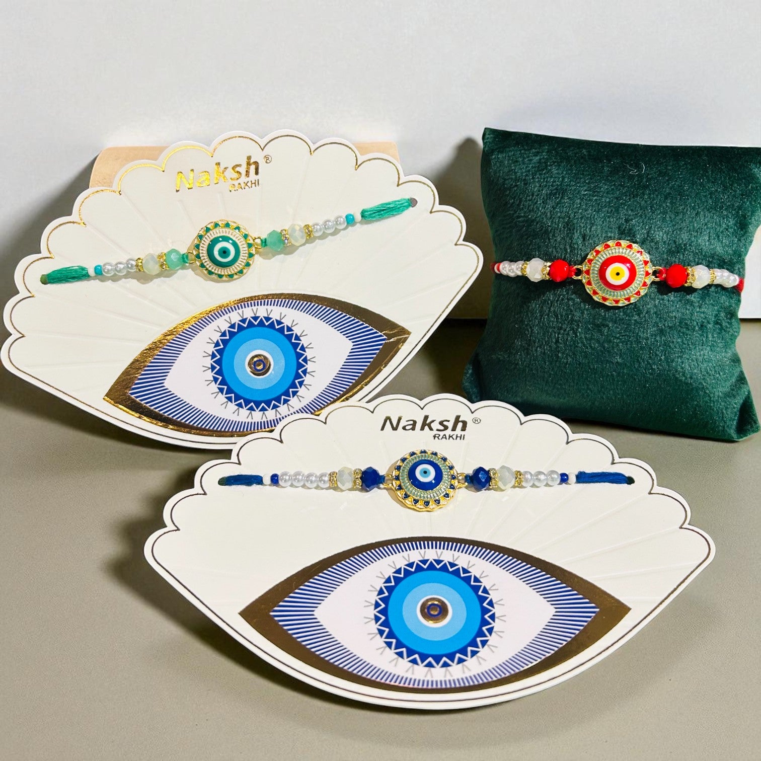 Evil Eye Rakhi (Design 2210) with blue nazar battu charm and thread work, includes Roli Chawal – by Wrap Shap