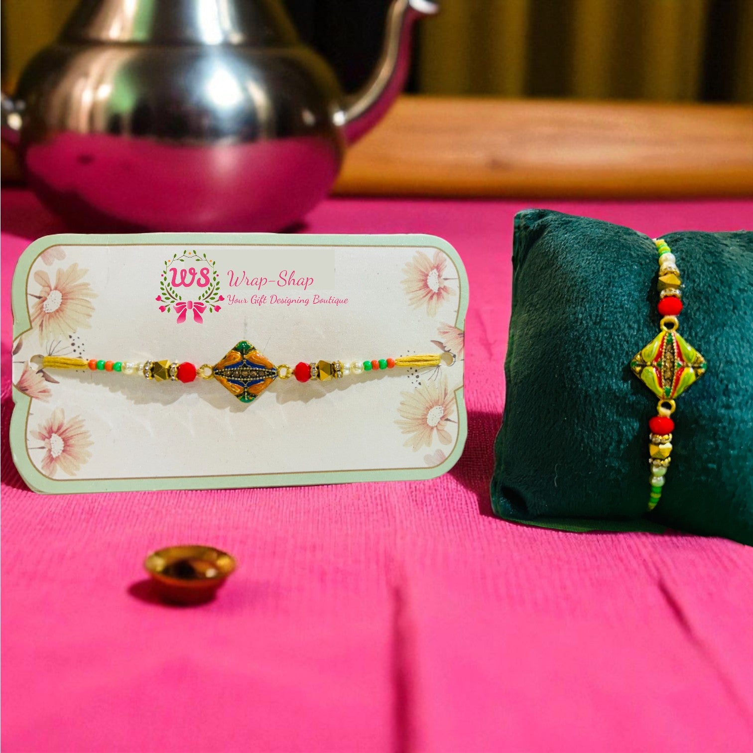 Rakhi with painted diamond-shaped metal charm in center, decorated with colorful festive beads – Wrap Shap