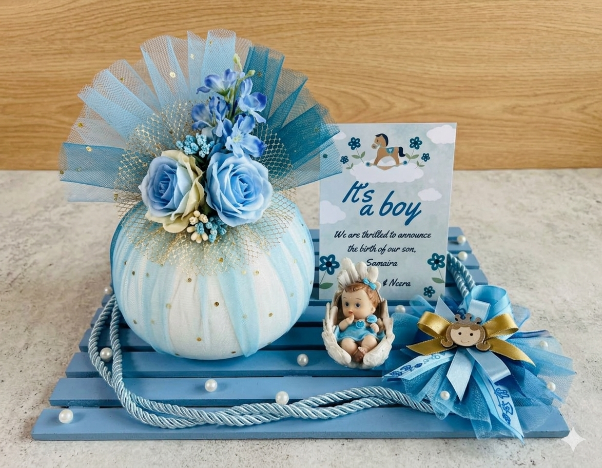 Decorative Baby Boy Gift Hamper with Rasgulla Jar, flowers, and baby-themed items on a wooden platter