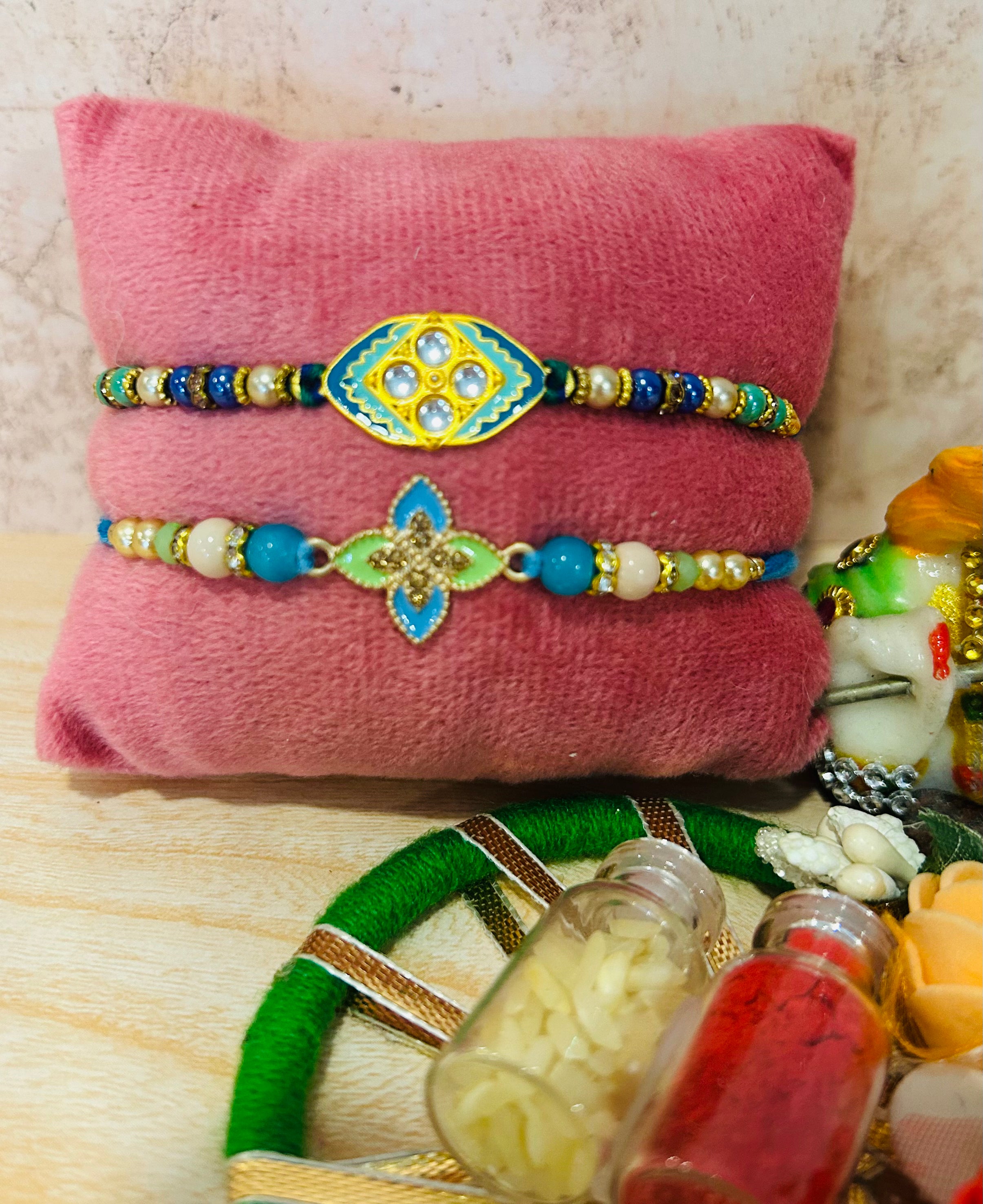 Pastel-Shaded Metal Charm Rakhi – Set of 2 Elegant Rakhis with Roli Chawal | Wrap Shap