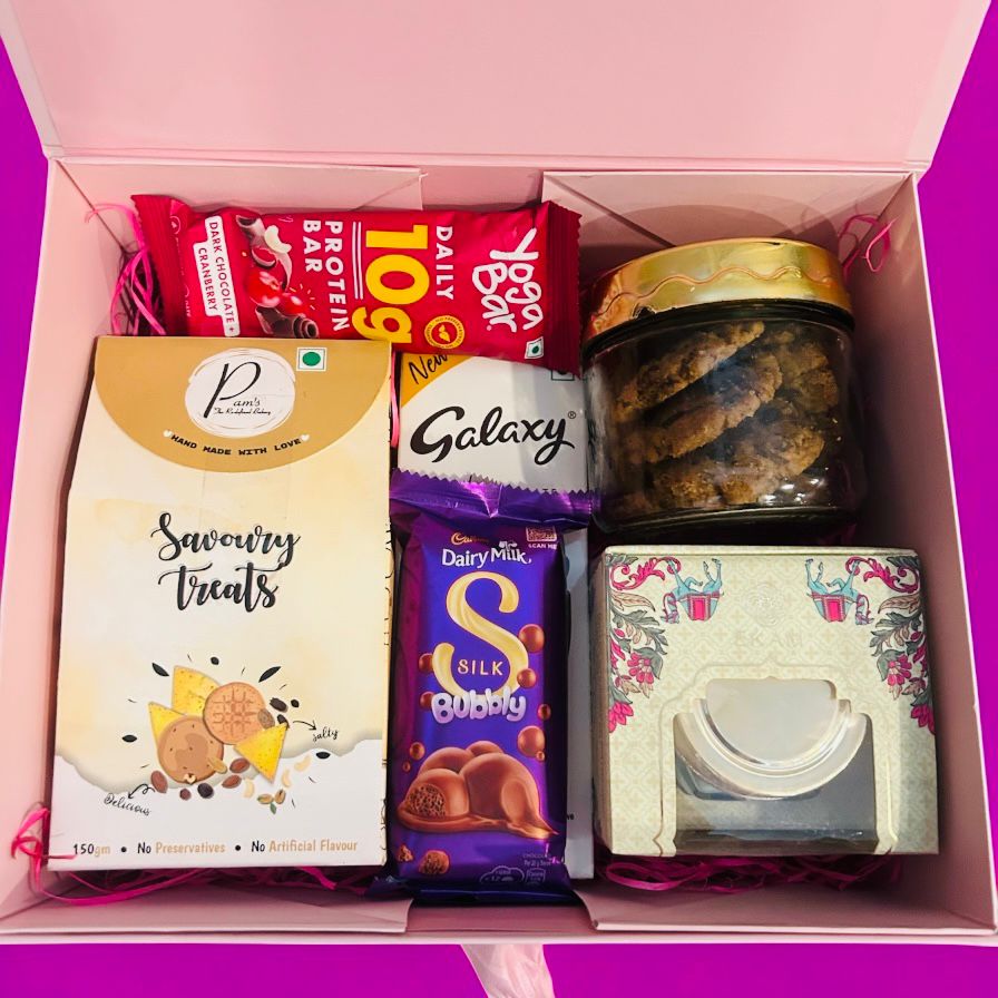 Mother’s Day gift hamper in rigid box with two cookie jars, scented candle, chocolates, protein bar, and custom name label from Wrap Shap