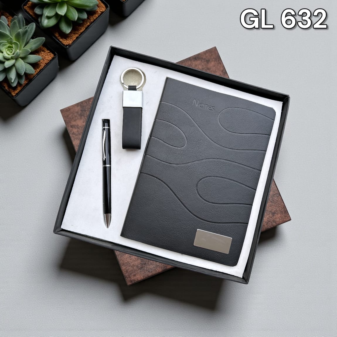 3-in-1 corporate gift set with charcoal A5 notebook, matte black pen, and hook keychain