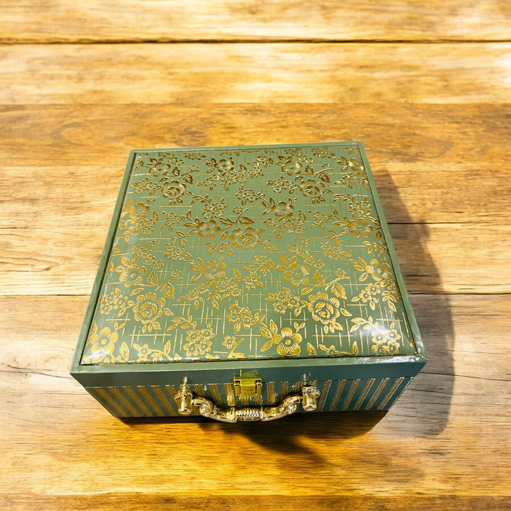 Green and brown rexin dry fruit gift box with gold foil detailing, 4 airtight glass jars, luxury premium gifting solution for weddings, festivals, and corporate events.