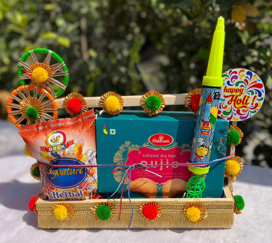 Holi Spectacle Hamper: Herbal Gulal, Gujiya, and Decorative Pichkari in Decorated Pinewood Basket