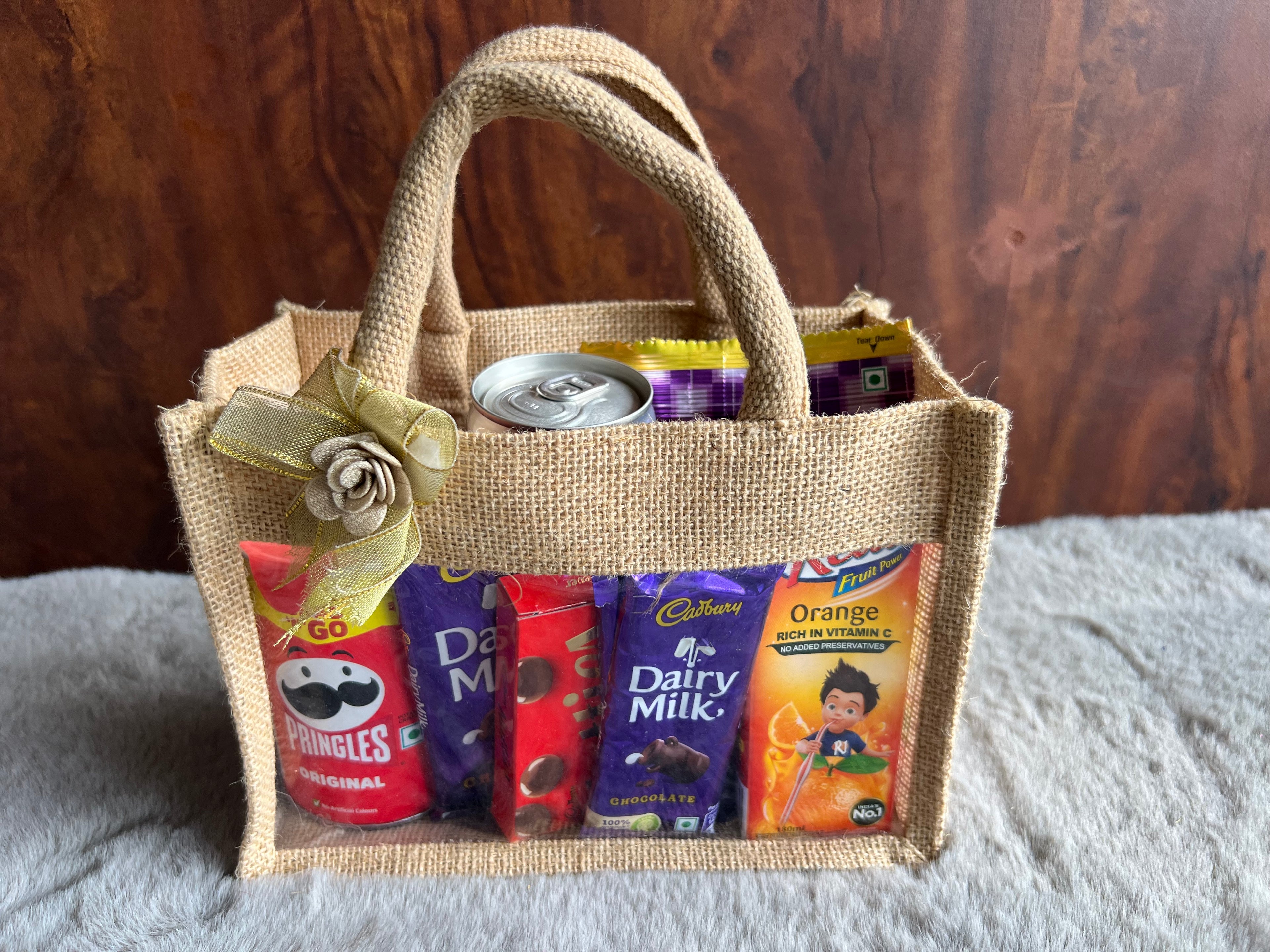 Snack Delight Rakhi Hamper with Pringles, Tong Garden Peanuts, Coke, Juice & Chocolates in Jute Gifting Bag
