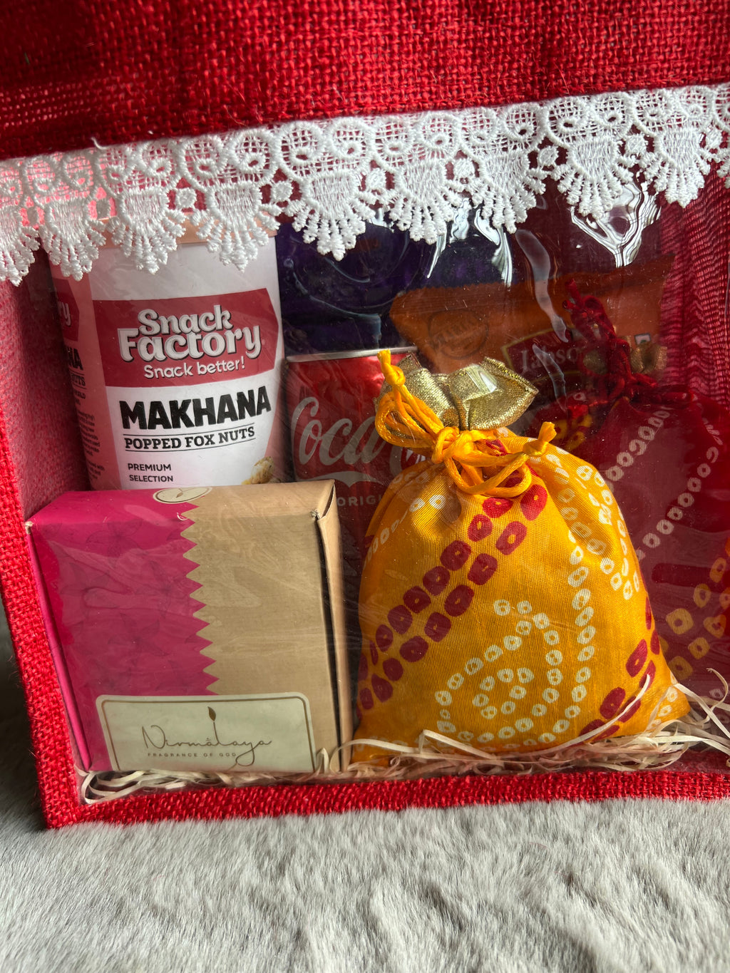 Divine Treats Rakhi Hamper with Makhana, Peanuts, Coke, Incense Cones, Coated Almonds & Chocolates