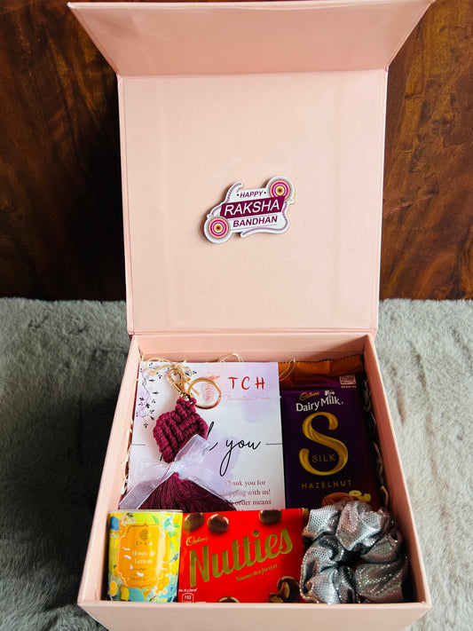 Chic Sister Rakhi Hamper with Crochet Keychain, Candle, Scrunchy & Chocolates in a Stylish Gift Box