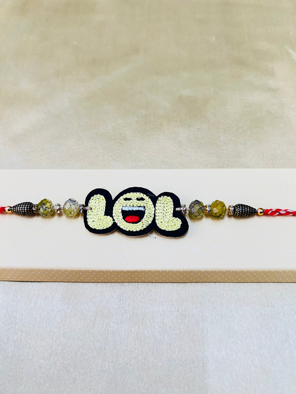 Wrap Shap RM808: Designer Rakhi with LOL Patch and Roli Chawal