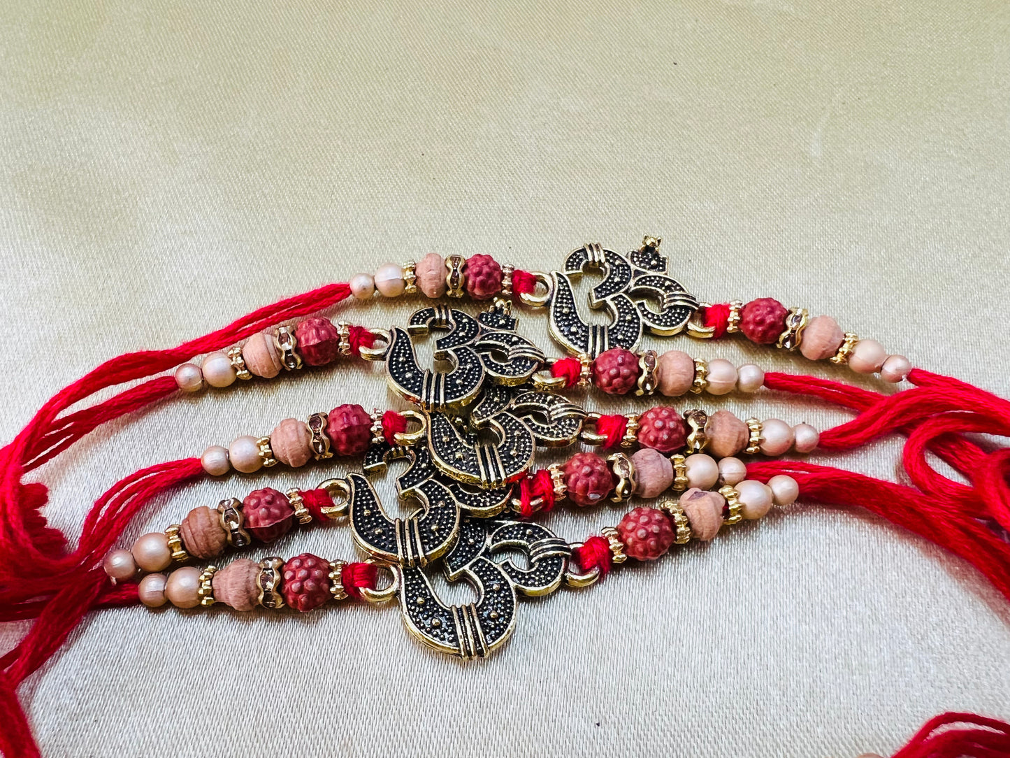 Wrap Shap WSR23-16: Designer Rakhi with Metal Om and Beads, Roli Chawal Included