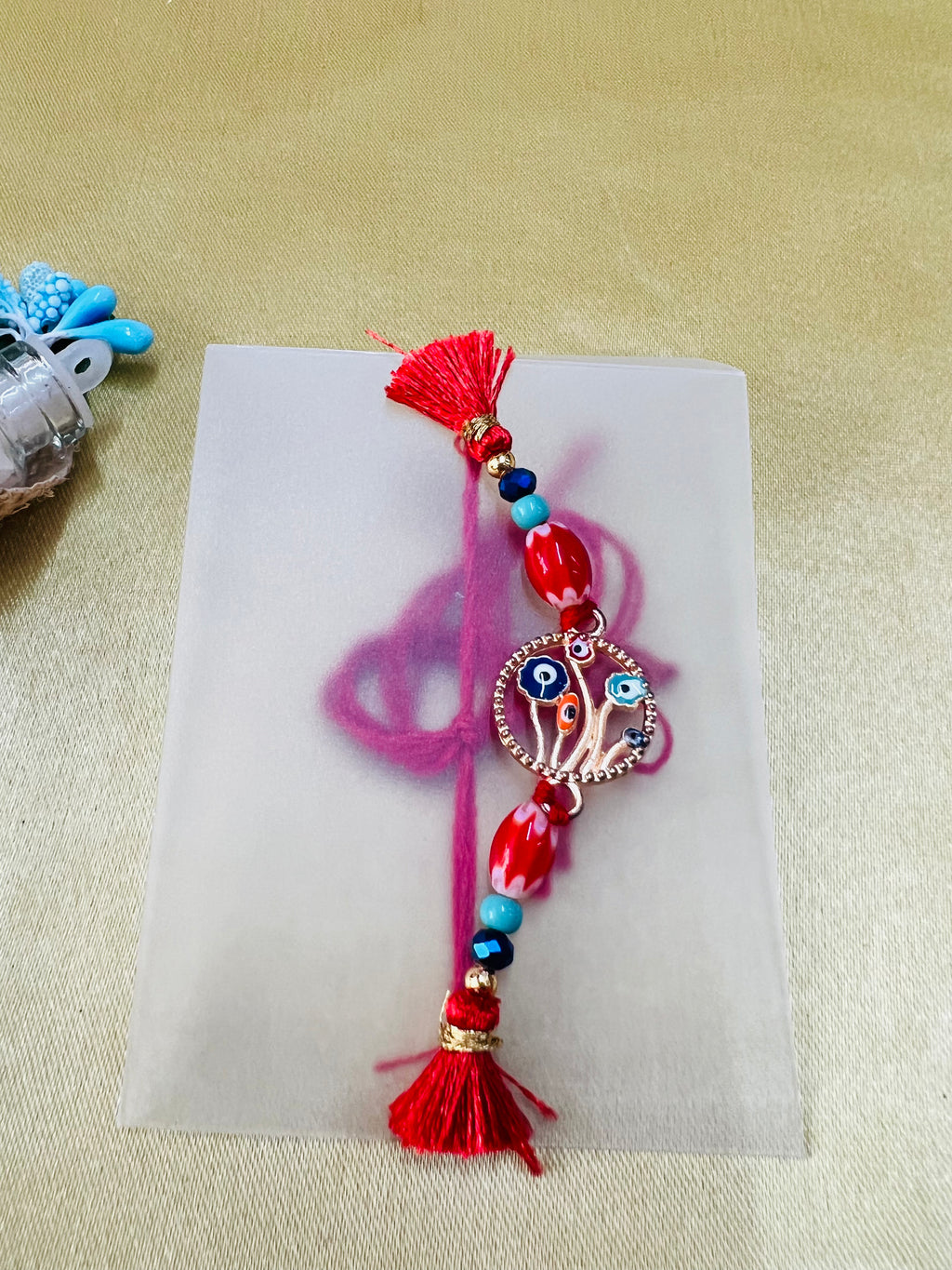 Wrap Shap BR-0107: Designer Rakhi with Evil Eye Protector and Beads, Roli Chawal Included