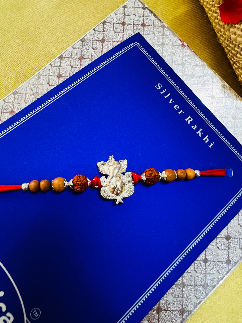 Wrap Shap Designer Rakhi with Silver Polished Ganesh, Beads, and Roli Chawal