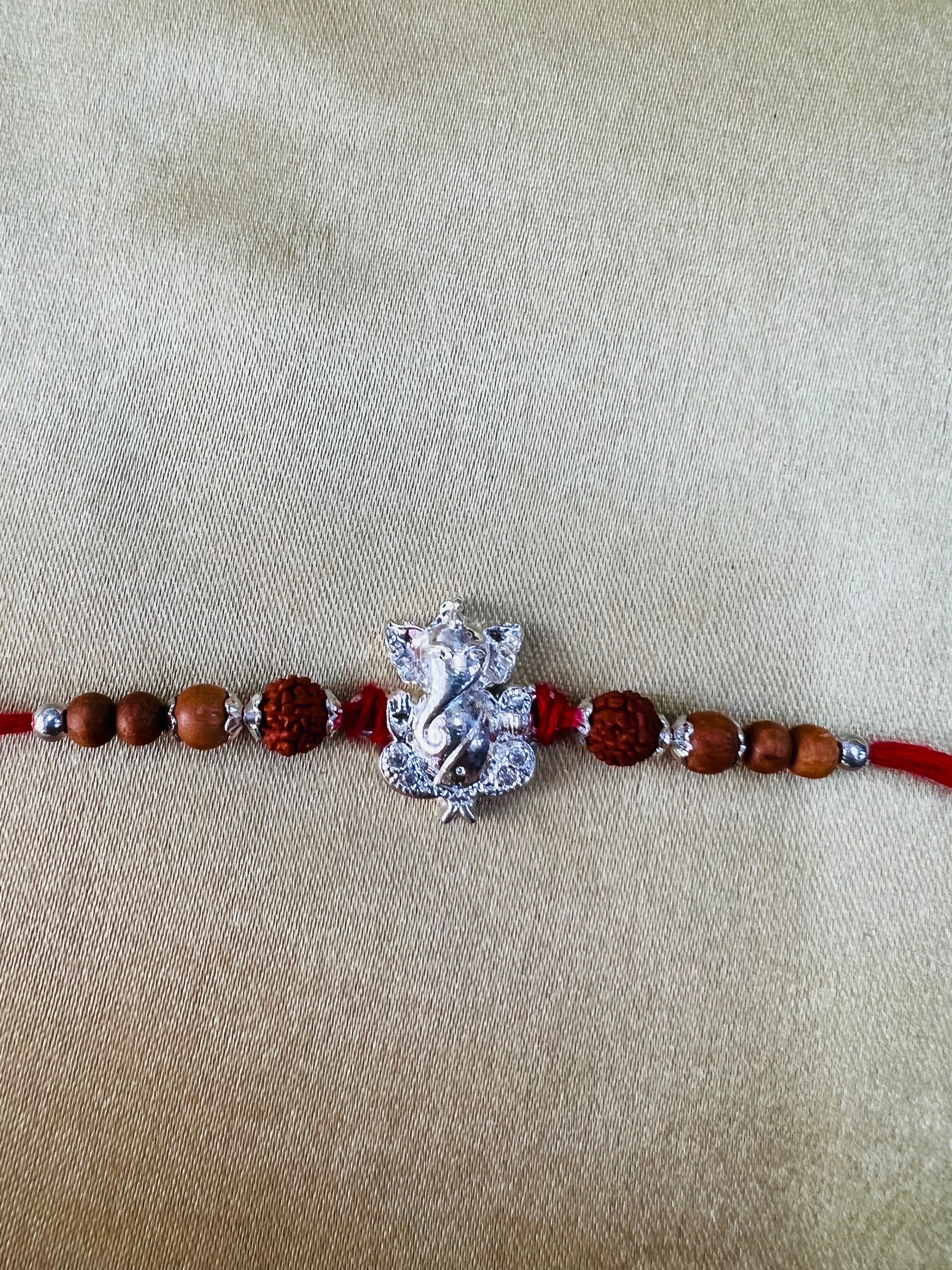 Wrap Shap Designer Rakhi with Silver Polished Ganesh, Beads, and Roli Chawal
