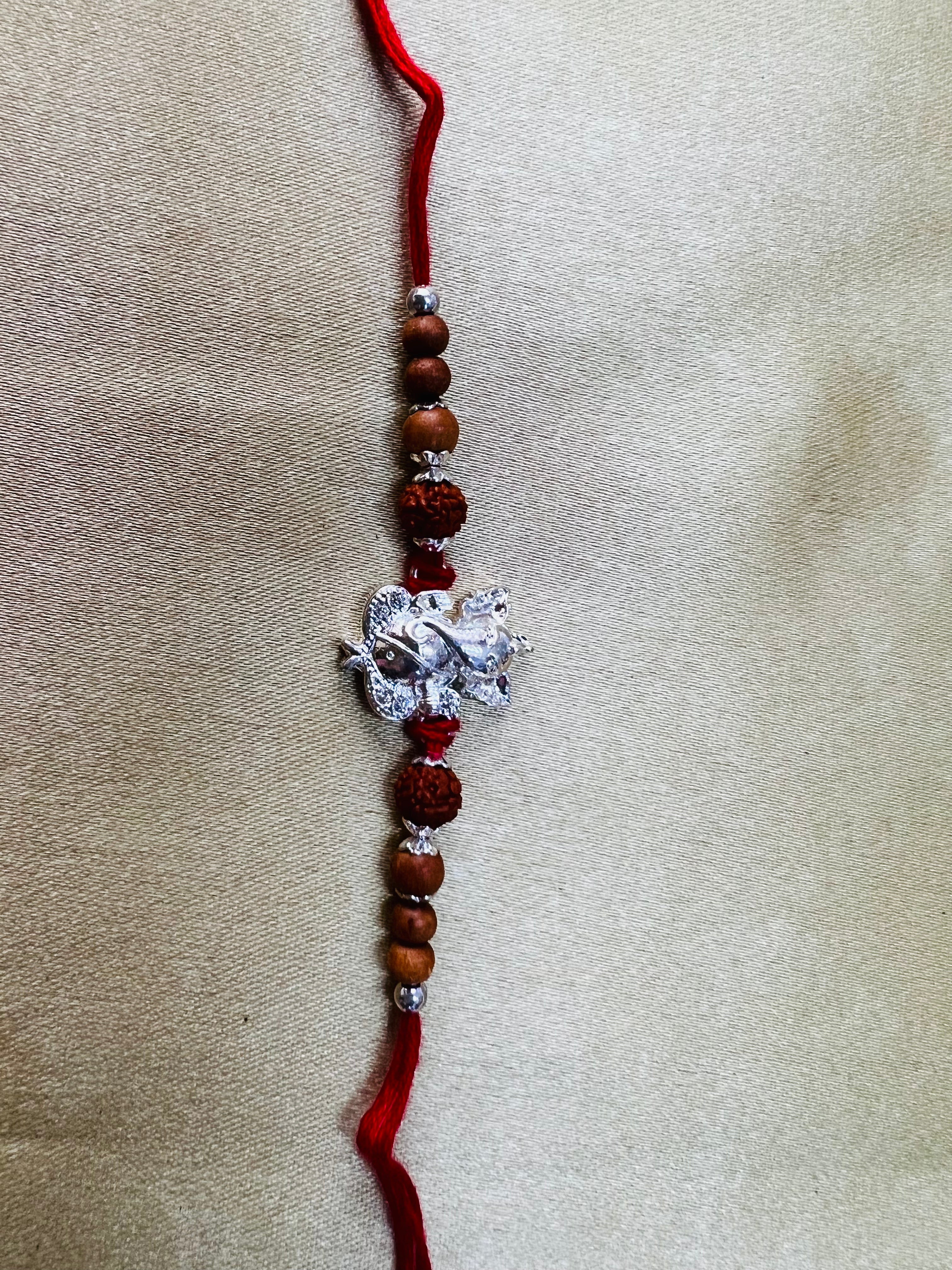 Wrap Shap Designer Rakhi with Silver Polished Ganesh, Beads, and Roli Chawal