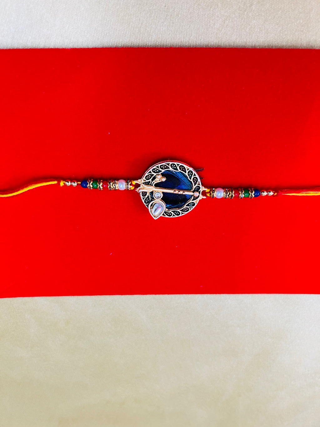 Wrap Shap GG01: Designer Rakhi with Peacock Feather and Krishna Flute Design, Roli Chawal Included