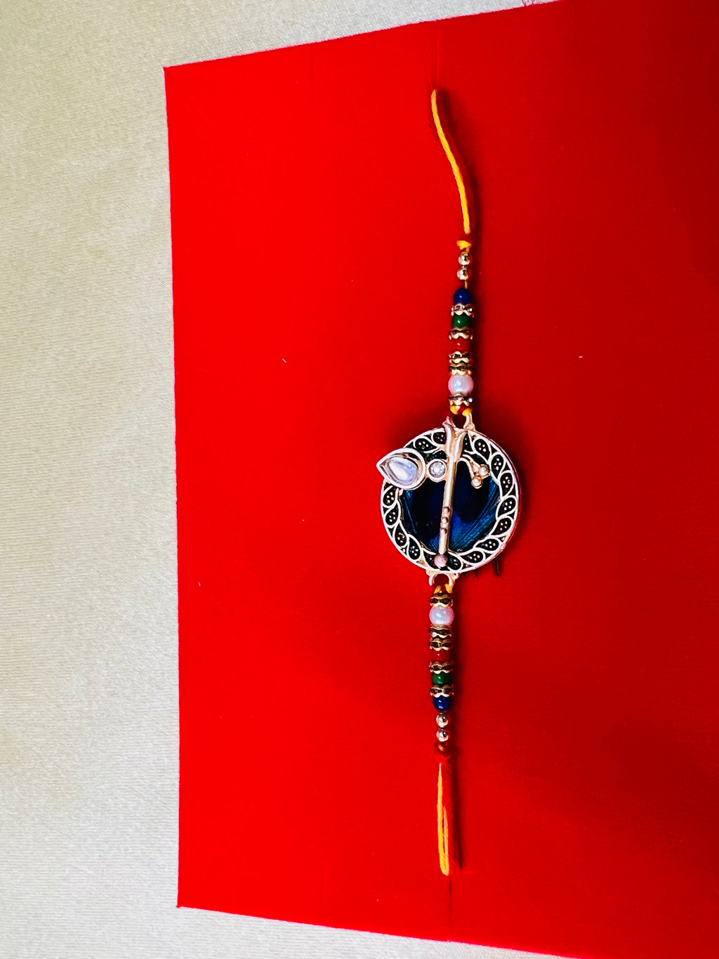 Wrap Shap GG01: Designer Rakhi with Peacock Feather and Krishna Flute Design, Roli Chawal Included