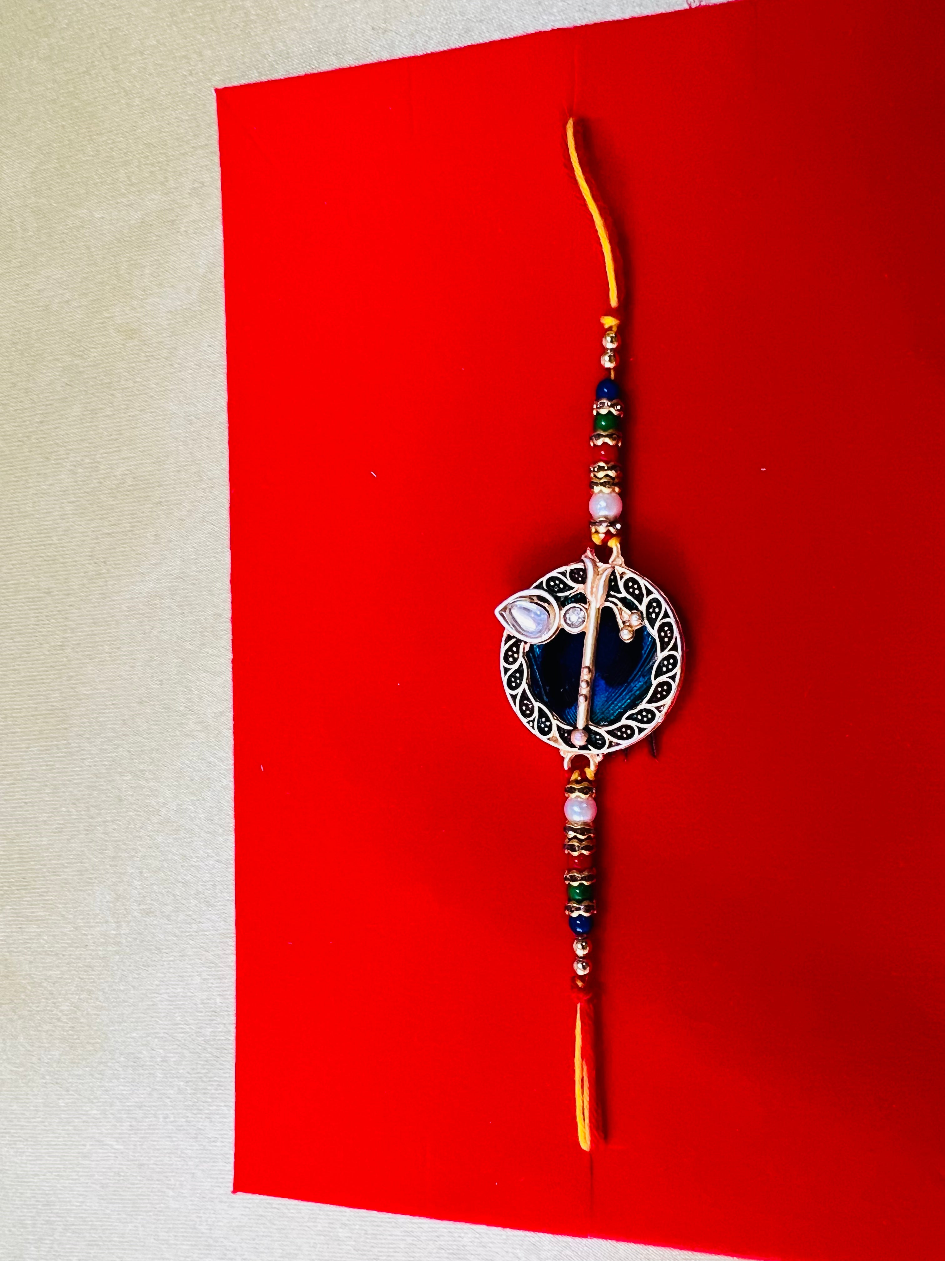 Wrap Shap GG01: Designer Rakhi with Peacock Feather and Krishna Flute Design, Roli Chawal Included