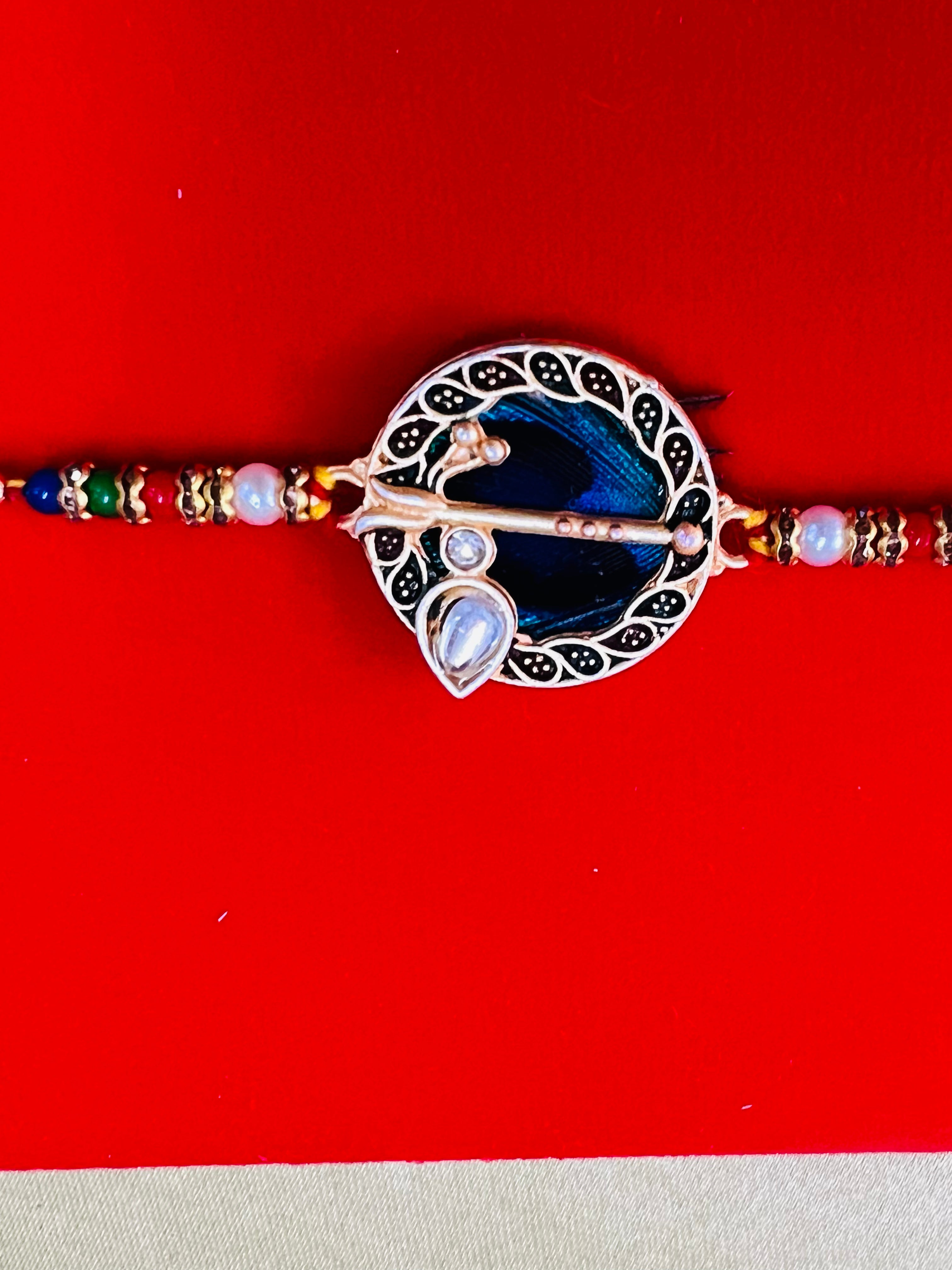 Wrap Shap GG01: Designer Rakhi with Peacock Feather and Krishna Flute Design, Roli Chawal Included