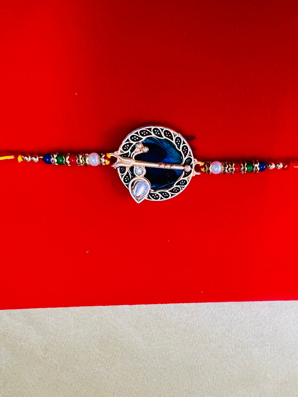 Wrap Shap GG01: Designer Rakhi with Peacock Feather and Krishna Flute Design, Roli Chawal Included