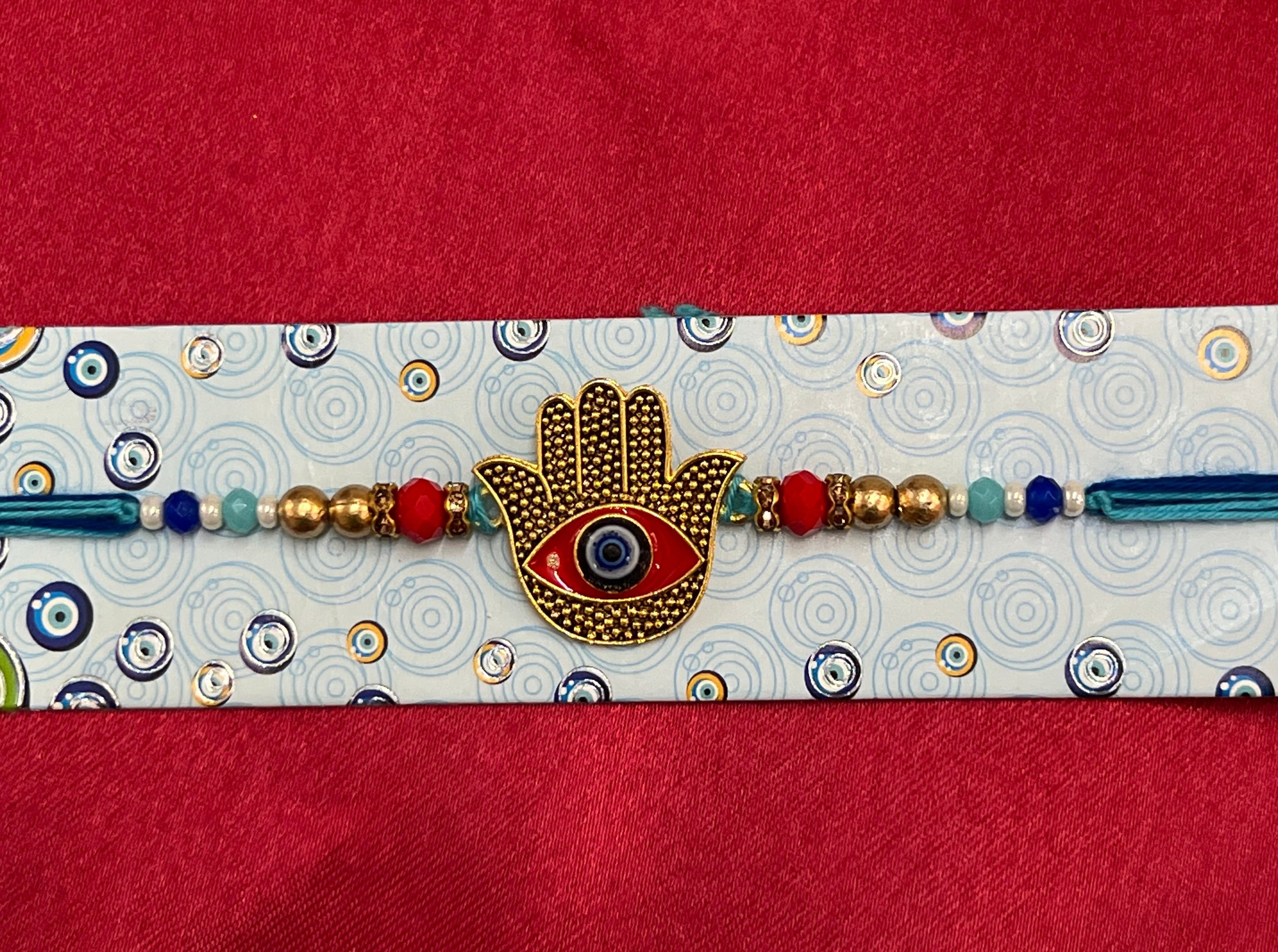 Wrap Shap 7517: Designer Rakhi with Hamsa Design Evil Eye, Roli Chawal Included