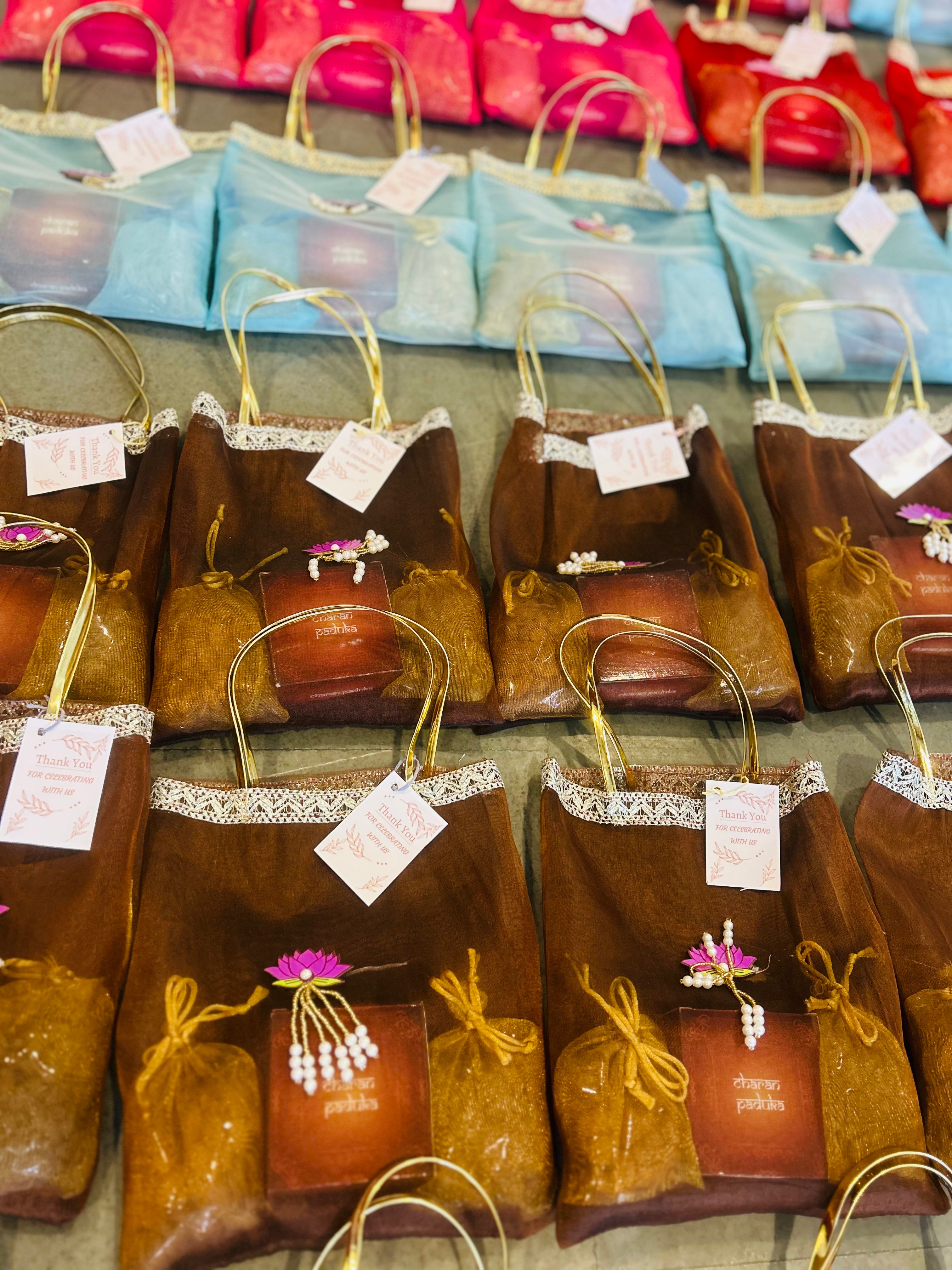 Premium Return Gift Hamper with Almonds, Raisins, Laxmi Charan Paduka Gift Box in Lotus Decorated Tissue Bag