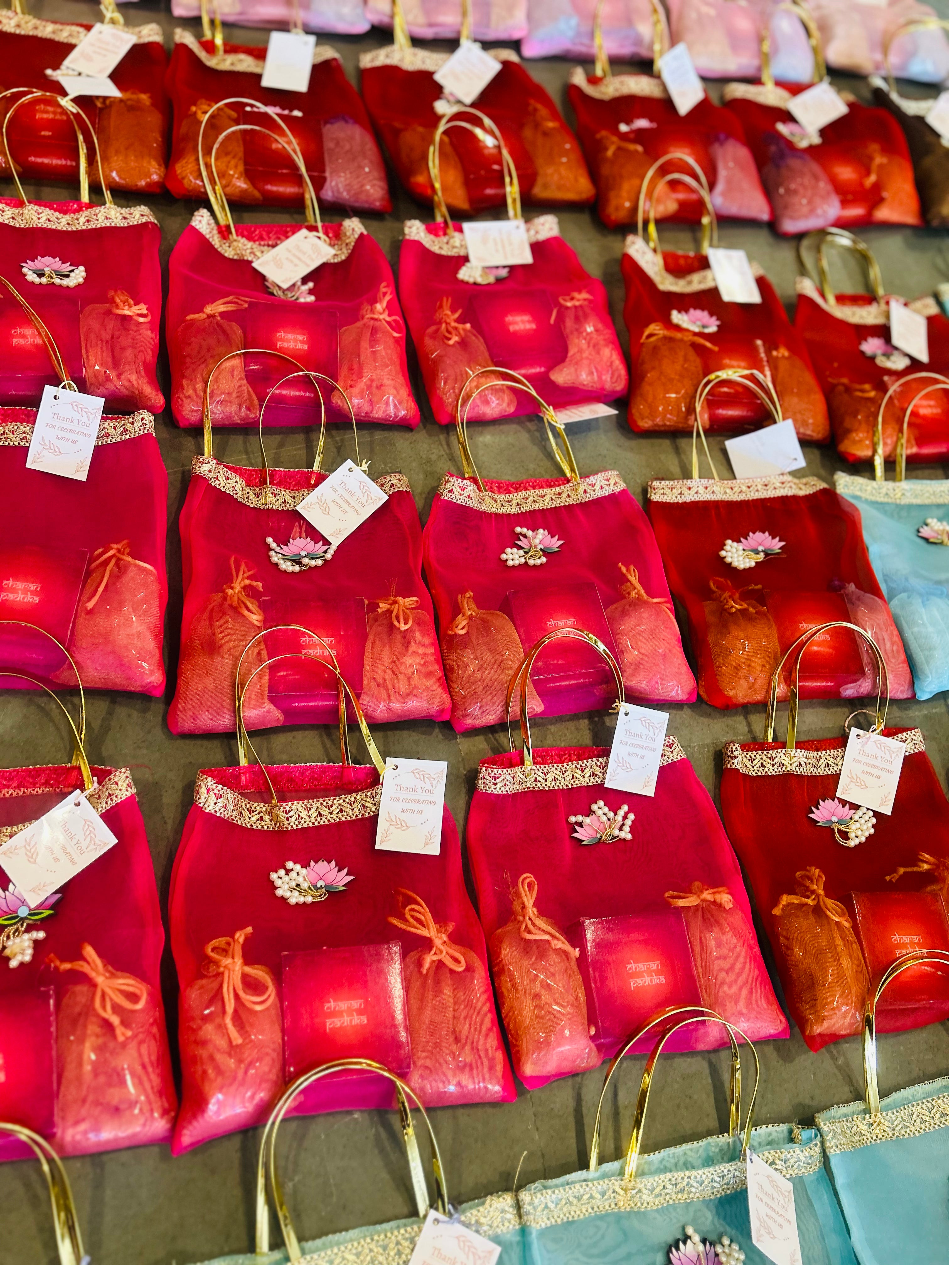 Premium Return Gift Hamper with Almonds, Raisins, Laxmi Charan Paduka Gift Box in Lotus Decorated Tissue Bag