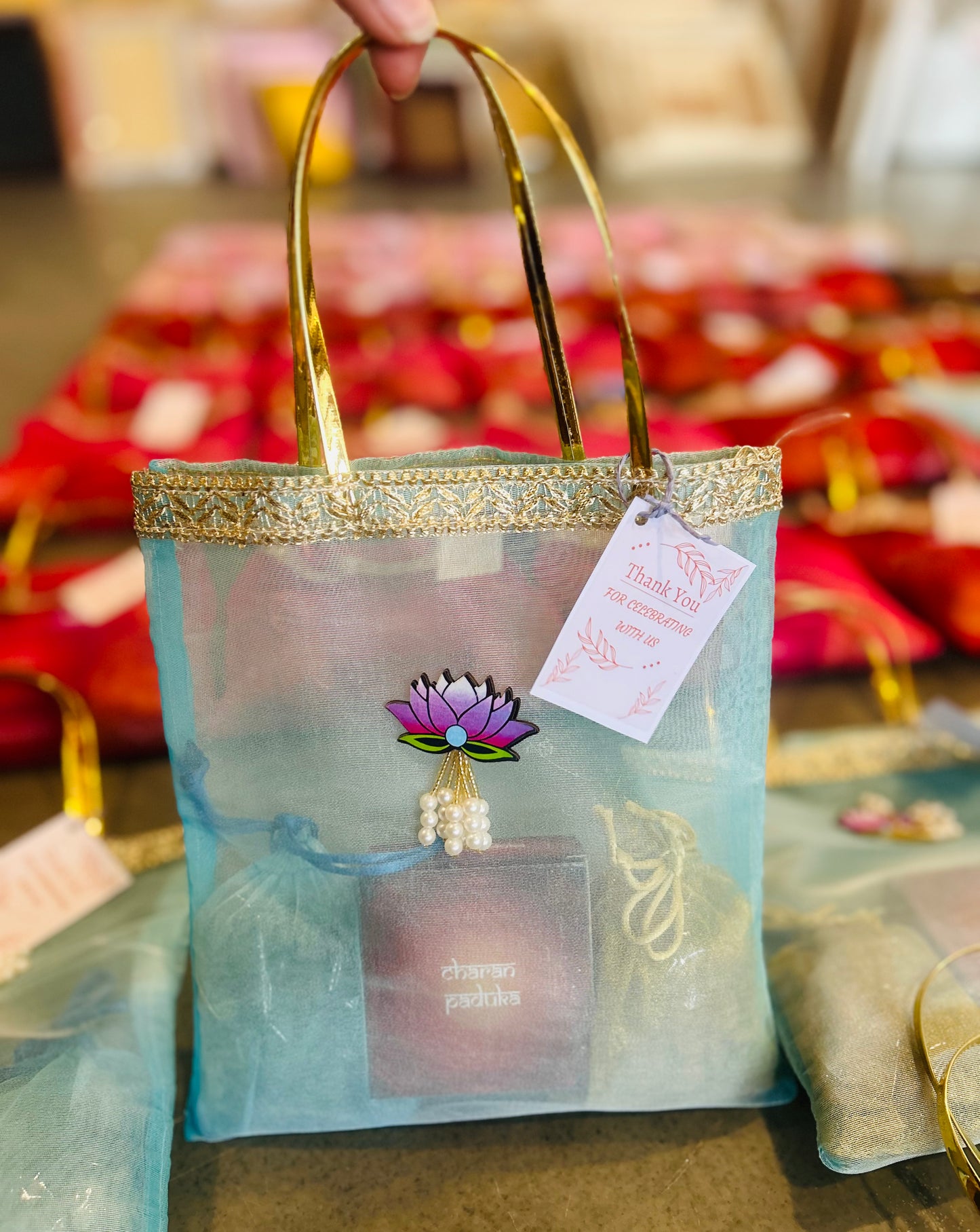 Premium Return Gift Hamper with Almonds, Raisins, Laxmi Charan Paduka Gift Box in Lotus Decorated Tissue Bag