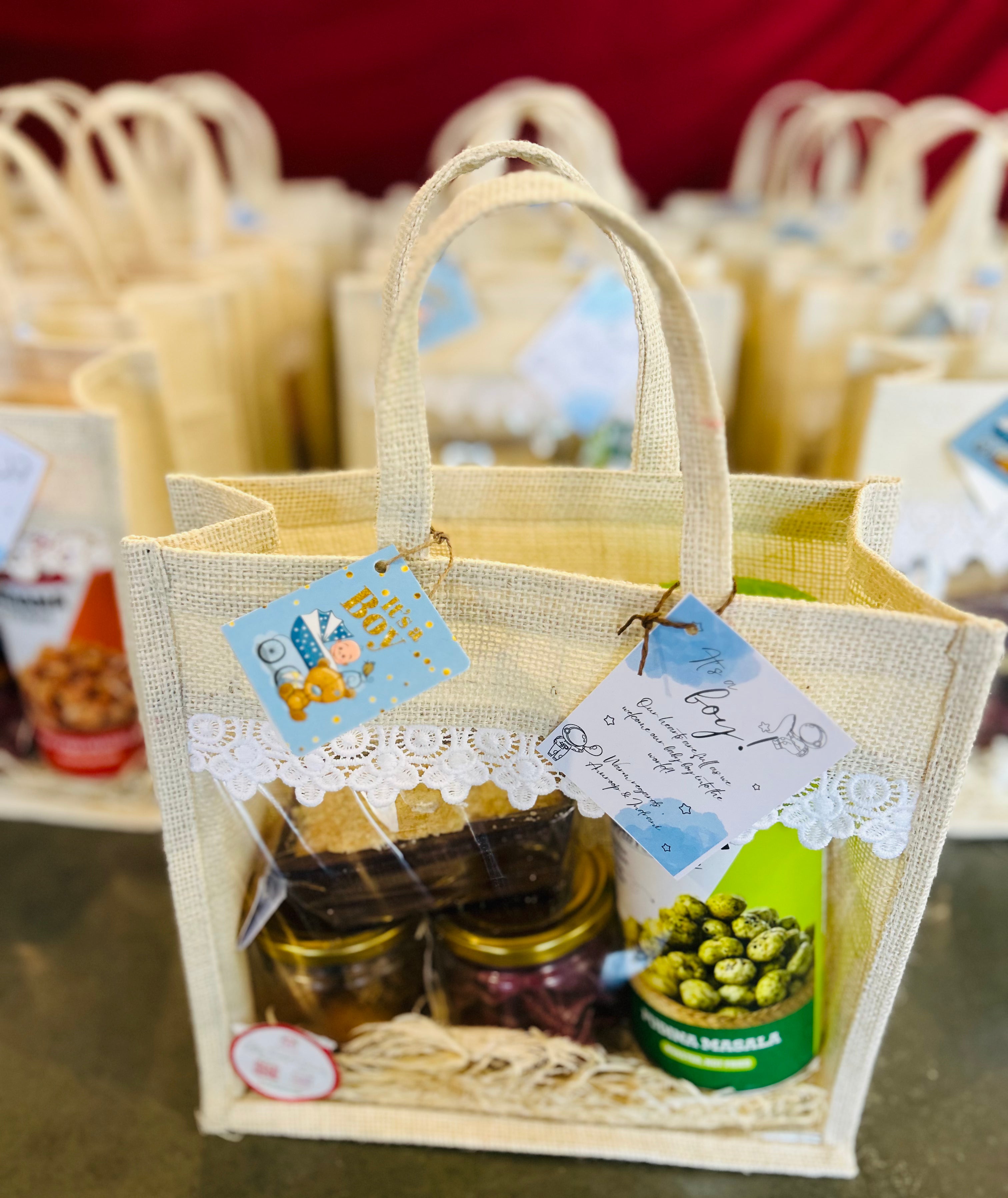 Premium jute bag hamper with gourmet treats including cookies, dry cake, soya chips & makhana
