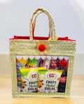 Holi hamper with colorful gulal, snacks, and snow spray in a decorative jute bag