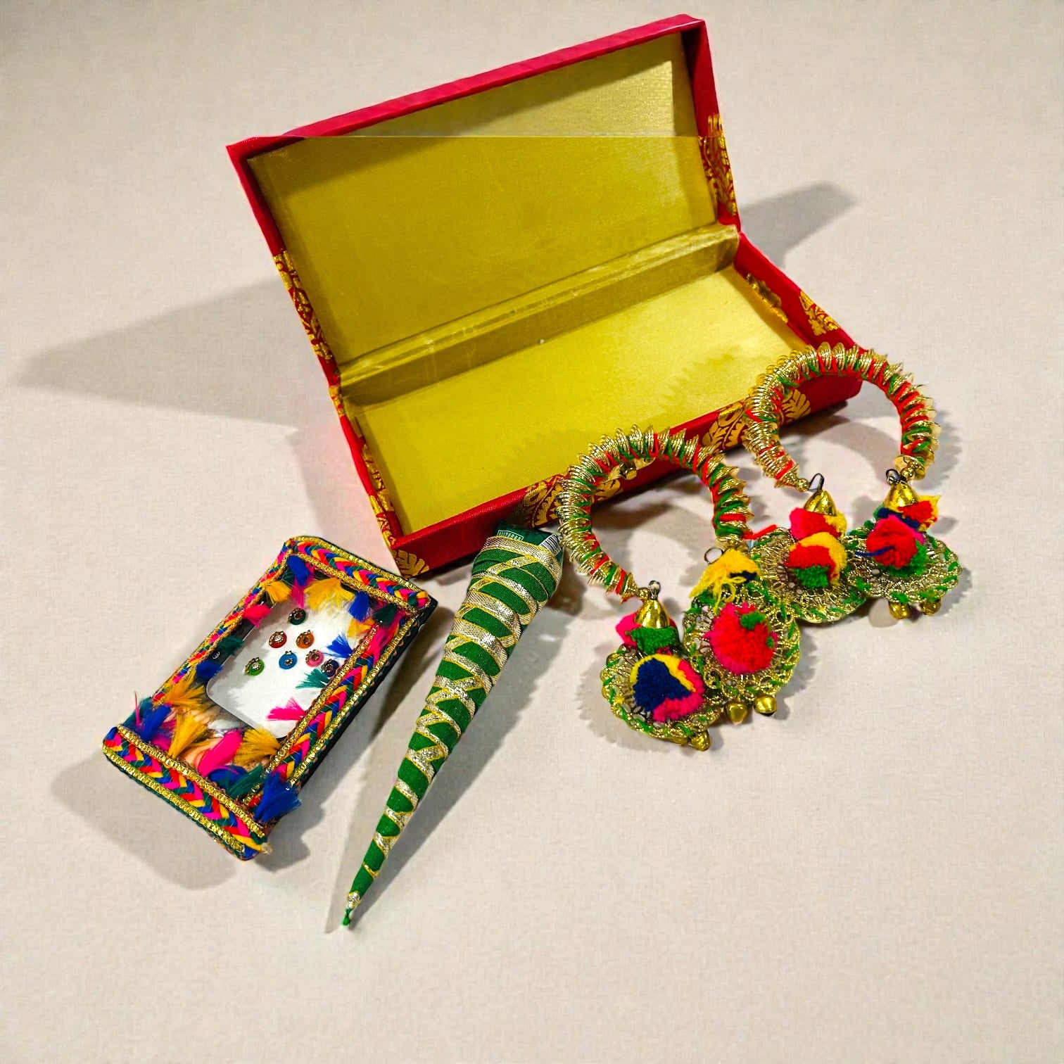 Haldi Mehendi wedding return gift for ladies featuring bindi, bangles and mehendi cone.