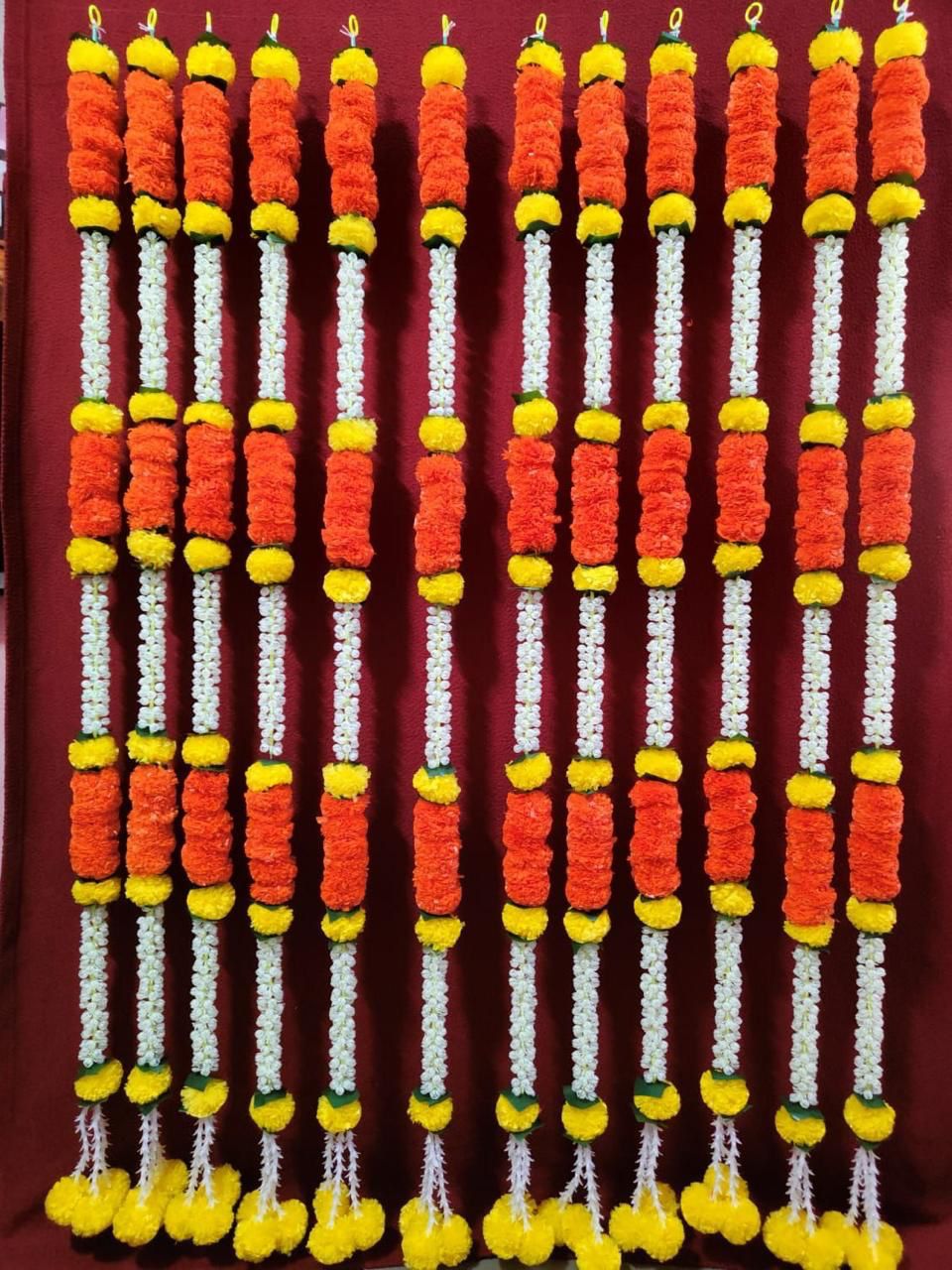 Decorative wall and door hanging with vibrant artificial flowers