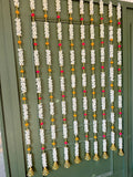 Decorative wall and door hanging with colorful pom poms and flowers
