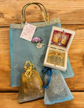 Premium Return Gift Hamper with Almonds, Raisins, Laxmi Charan Paduka Gift Box in Lotus Decorated Tissue Bag