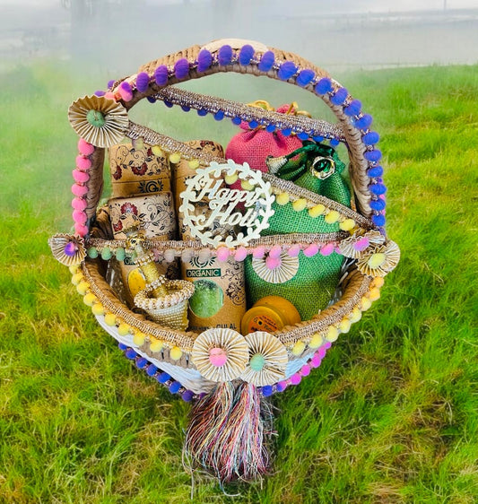 Holi Gift Hamper with Gujiya, Namak Pare, Organic Gulal, Pichkari & Chandan Tika in a Decorative Rafia Basket – Perfect for Personal & Corporate Gifting.