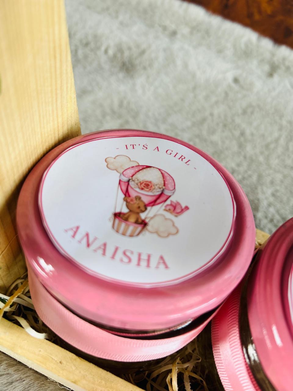 Premium cashew and almond glass jar gift hamper in decorated pinewood basket with flower decoration.