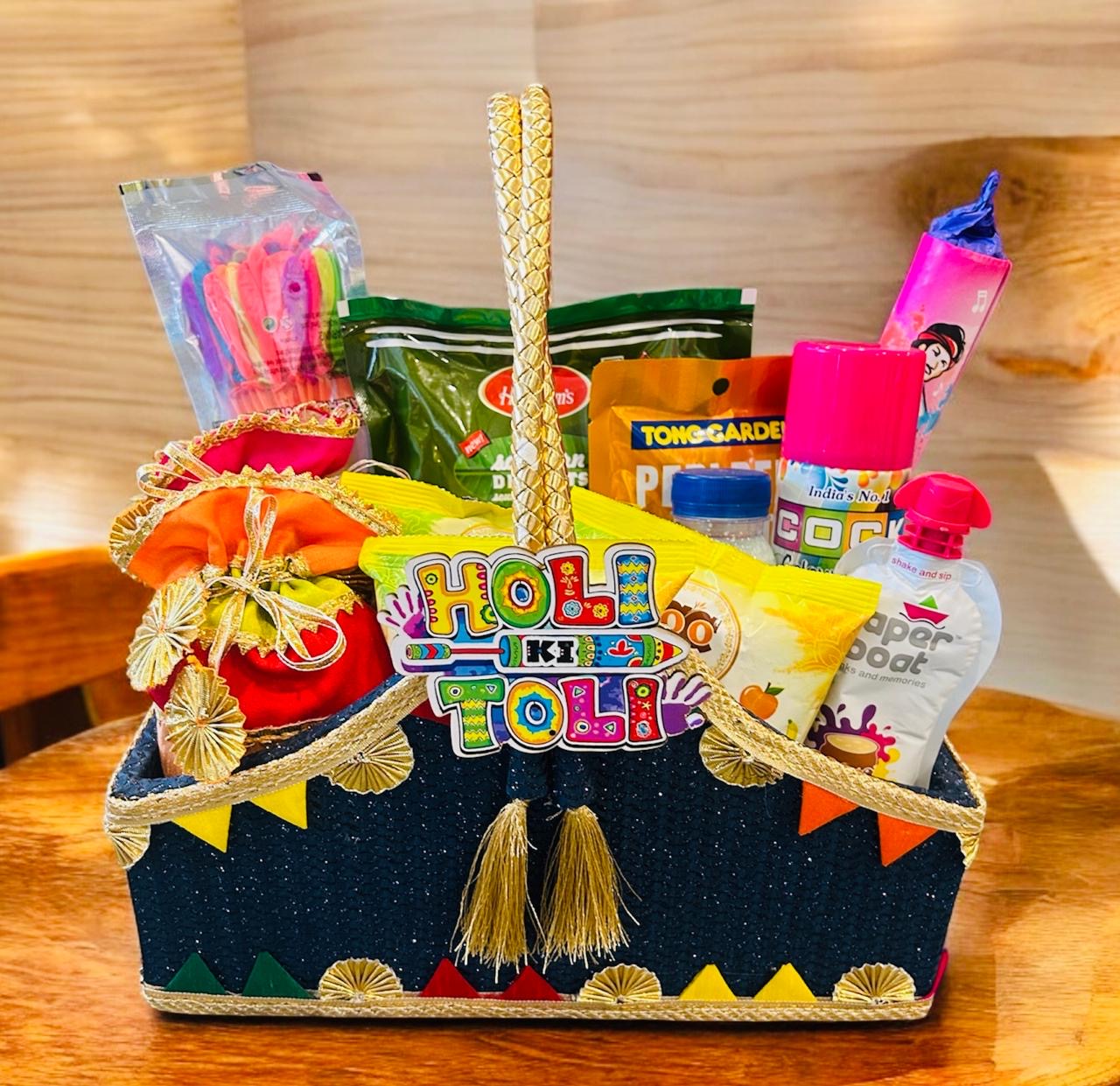 Premium Holi Gift Hamper with traditional sweets, snacks, organic gulal, and decorative potli and basket.