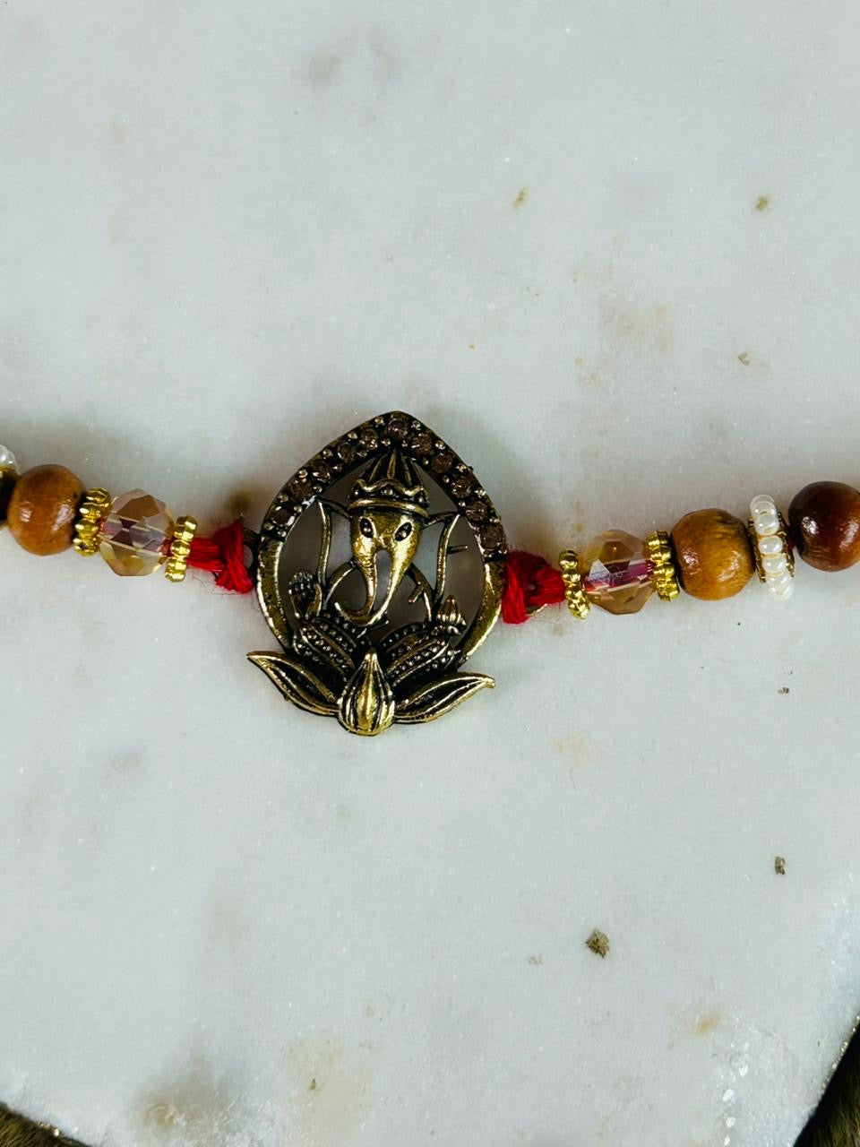 Wrap Shap 2307 Ganeshji on Lotus Metal Rakhi – Divine Blessings with Roli Chawal