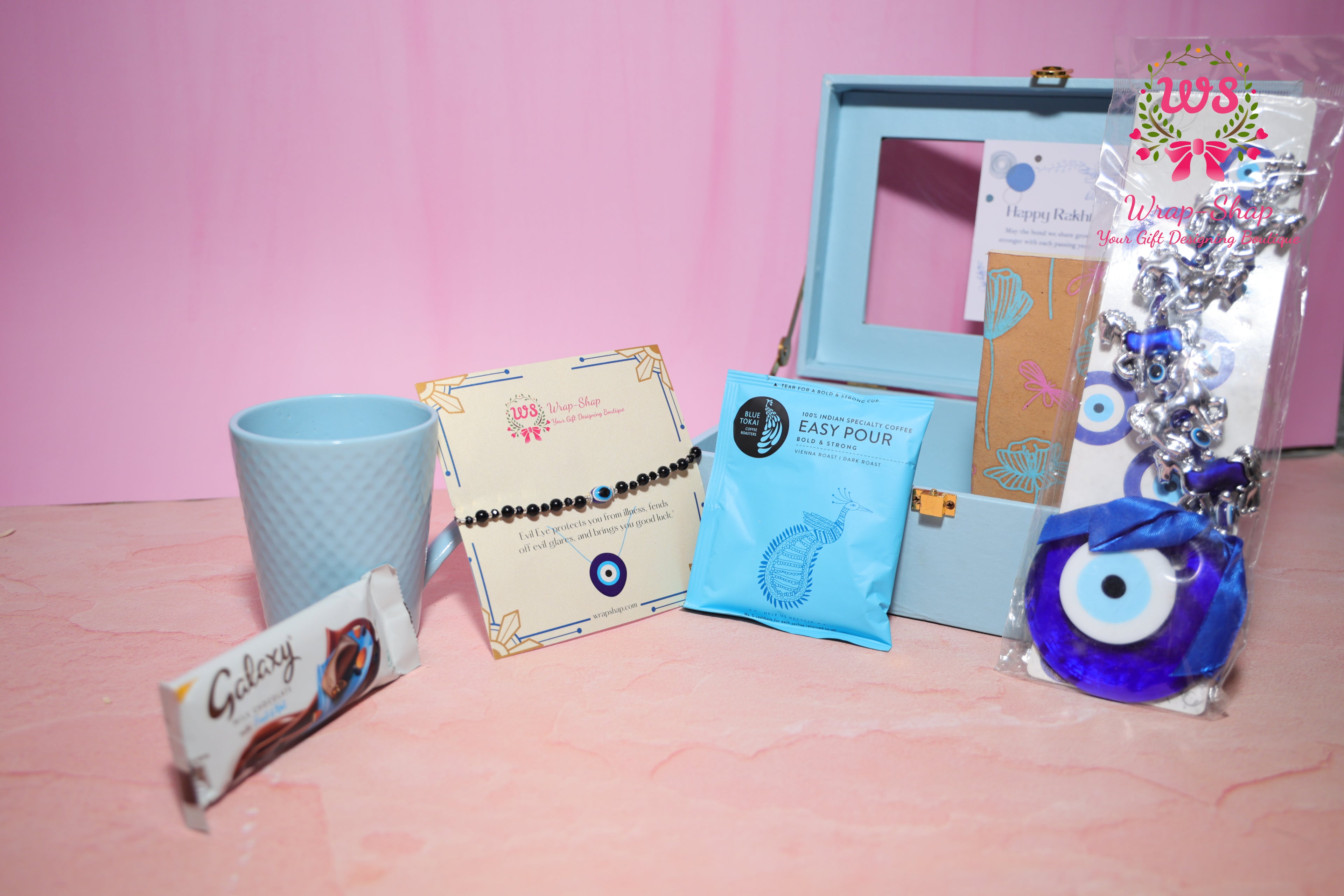 Evil Eye Rakhi Hamper with Blue Coffee Mug, Blue Tokai Coffee, Notebook, Chocolate & Rakhi in Blue MDF Gift Box | Wrap Shap