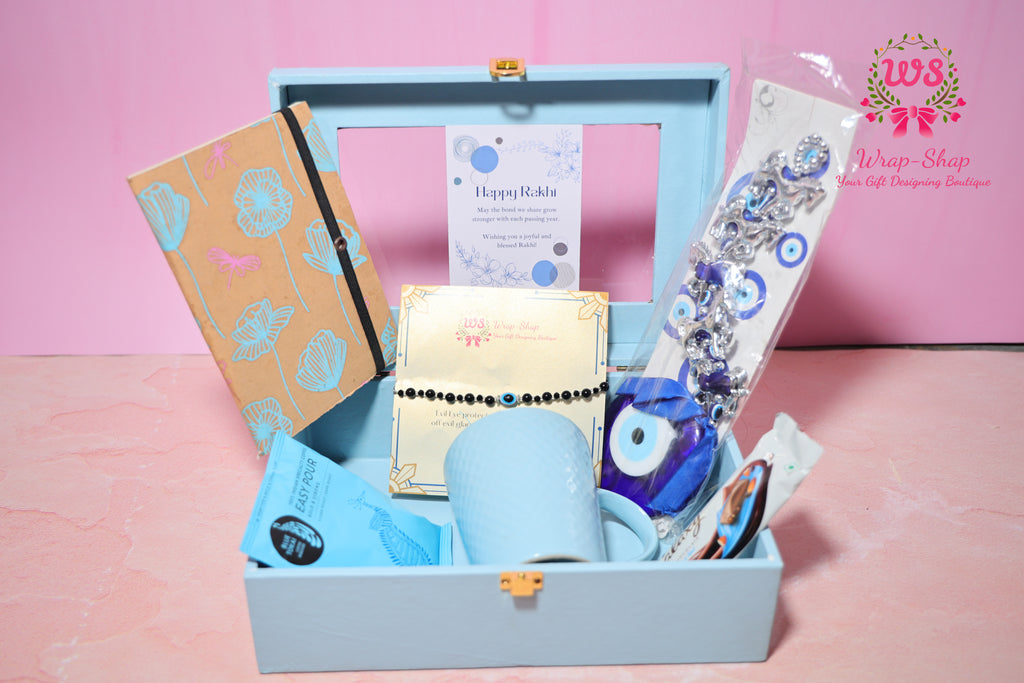 Evil Eye Rakhi Hamper with Blue Coffee Mug, Blue Tokai Coffee, Notebook, Chocolate & Rakhi in Blue MDF Gift Box | Wrap Shap