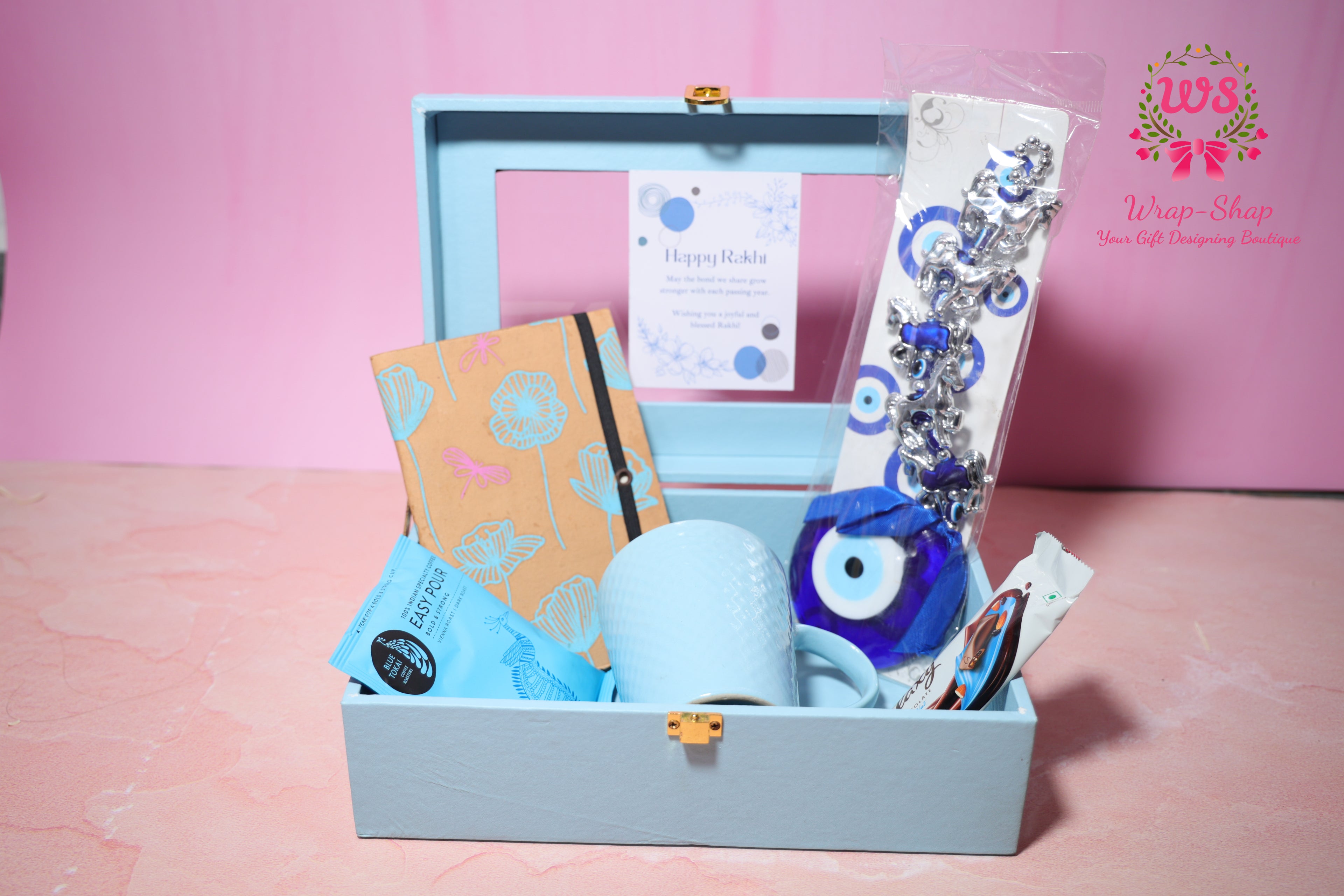 Evil Eye Rakhi Hamper with Blue Coffee Mug, Blue Tokai Coffee, Notebook, Chocolate & Rakhi in Blue MDF Gift Box | Wrap Shap