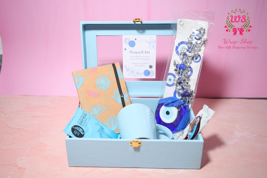 Evil Eye Rakhi Hamper with Blue Coffee Mug, Blue Tokai Coffee, Notebook, Chocolate & Rakhi in Blue MDF Gift Box | Wrap Shap