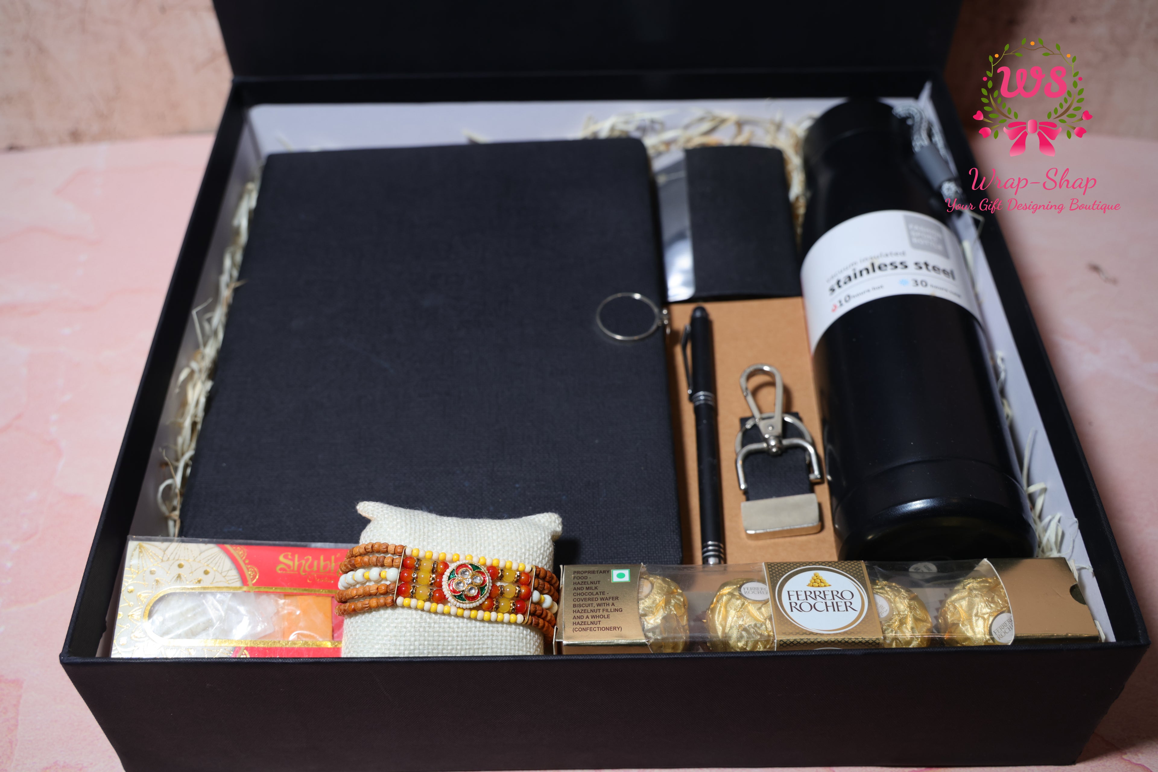 Rakhi Hamper with Customized Steel Bottle, Notebook, Pen, Card Holder, Keychain, Ferrero Rocher & Rakhi in Rigid Gift Box | Wrap Shap