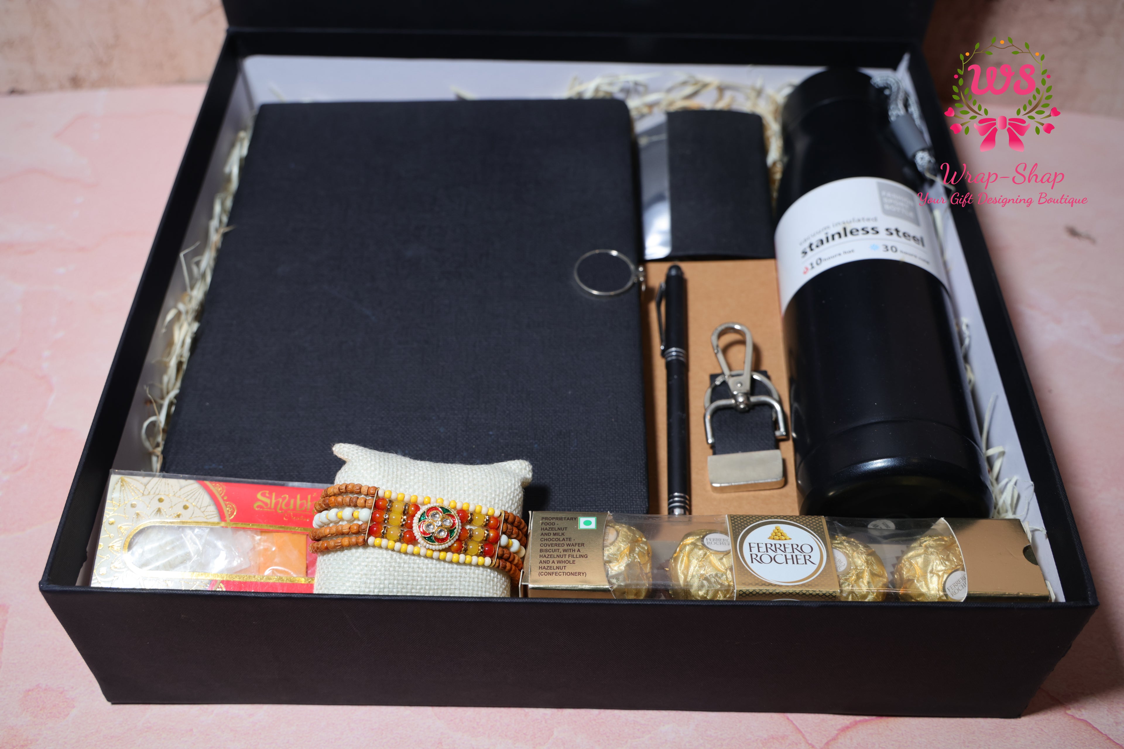 Rakhi Hamper with Customized Steel Bottle, Notebook, Pen, Card Holder, Keychain, Ferrero Rocher & Rakhi in Rigid Gift Box | Wrap Shap