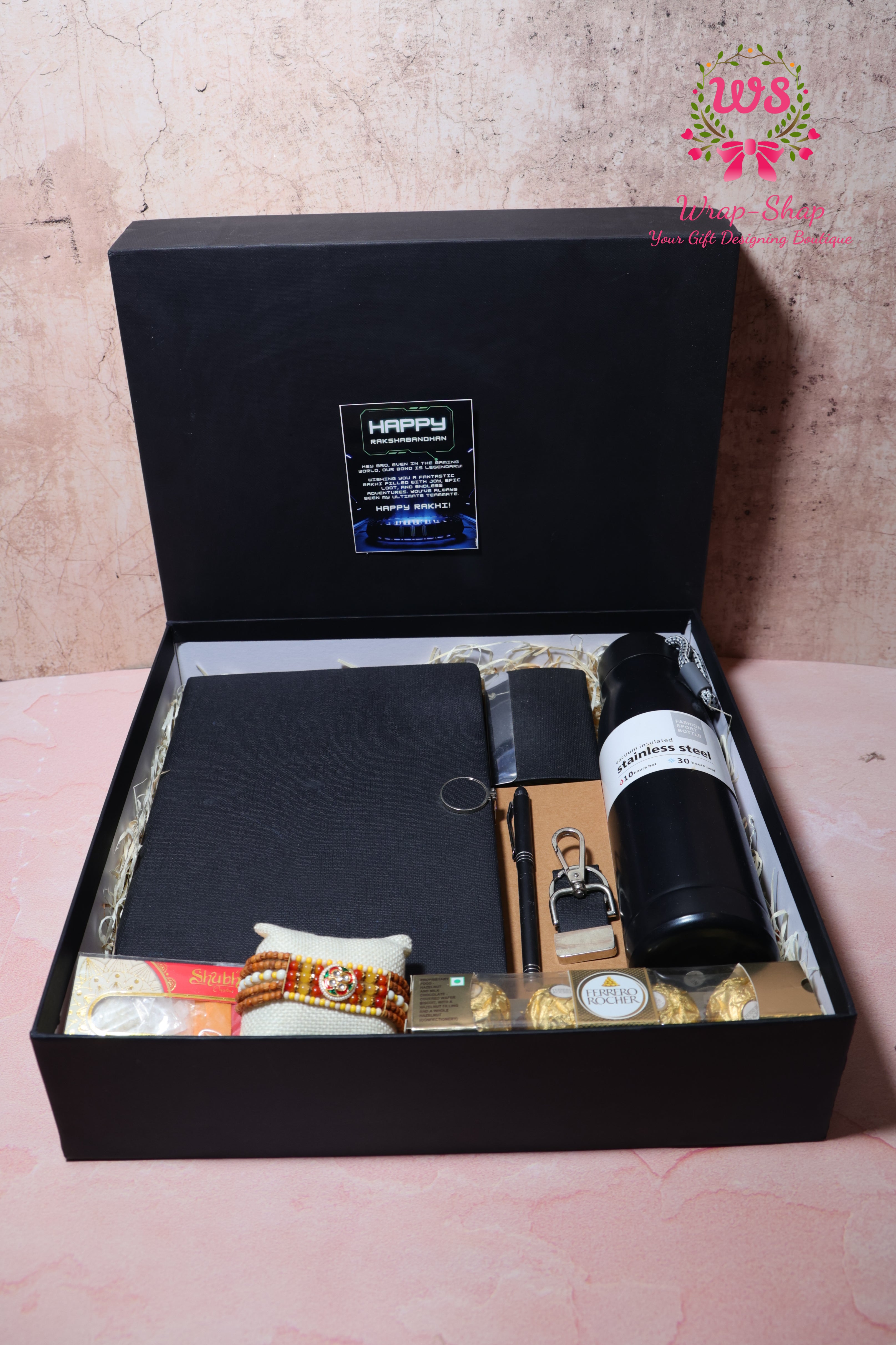 Rakhi Hamper with Customized Steel Bottle, Notebook, Pen, Card Holder, Keychain, Ferrero Rocher & Rakhi in Rigid Gift Box | Wrap Shap
