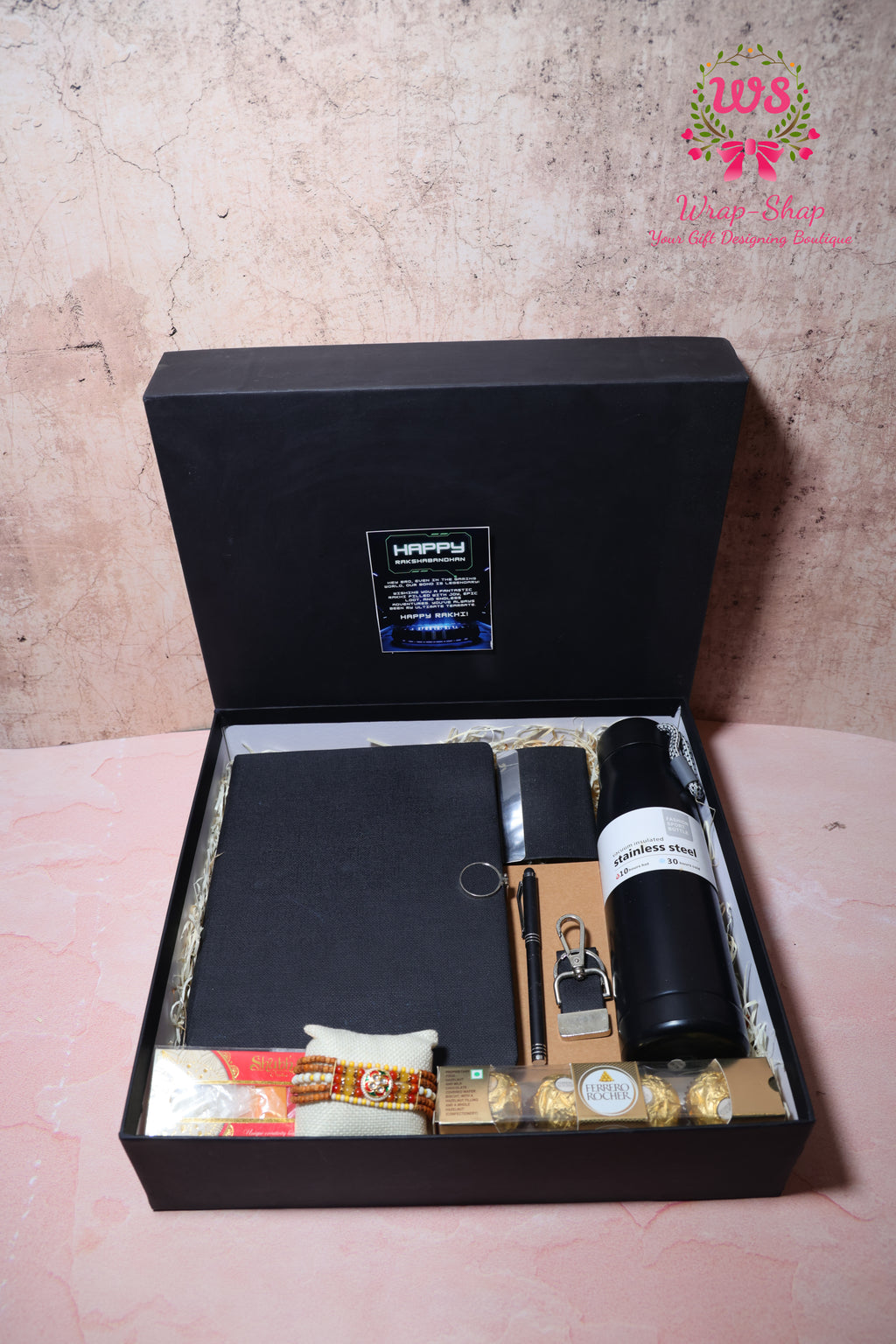 Rakhi Hamper with Customized Steel Bottle, Notebook, Pen, Card Holder, Keychain, Ferrero Rocher & Rakhi in Rigid Gift Box | Wrap Shap