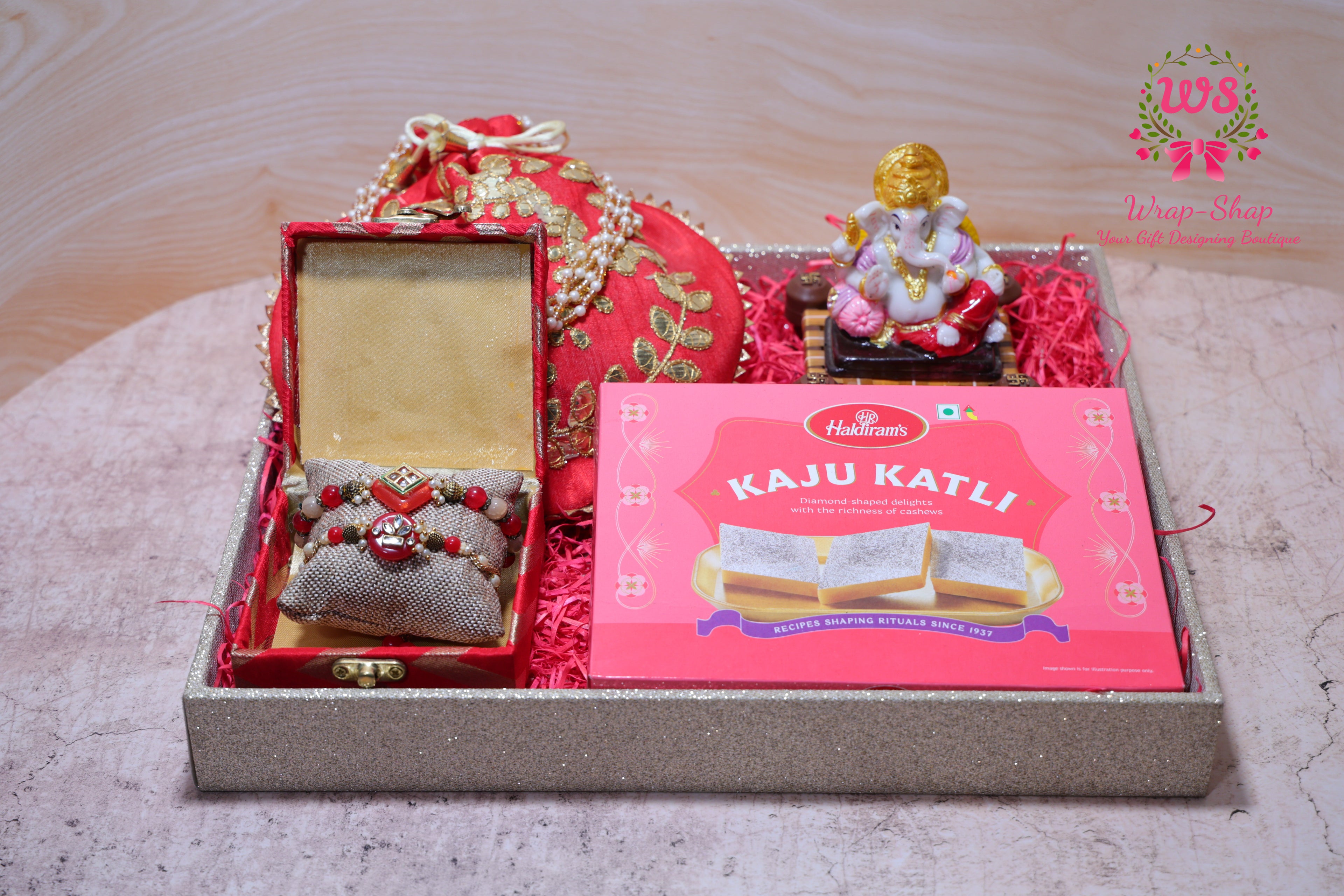 Bhaiya Bhabhi Rakhi Gift Hamper with Kaju Katli, Ganpati Idol, Potli & Tray | Raksha Bandhan Gift Box by Wrap Shap