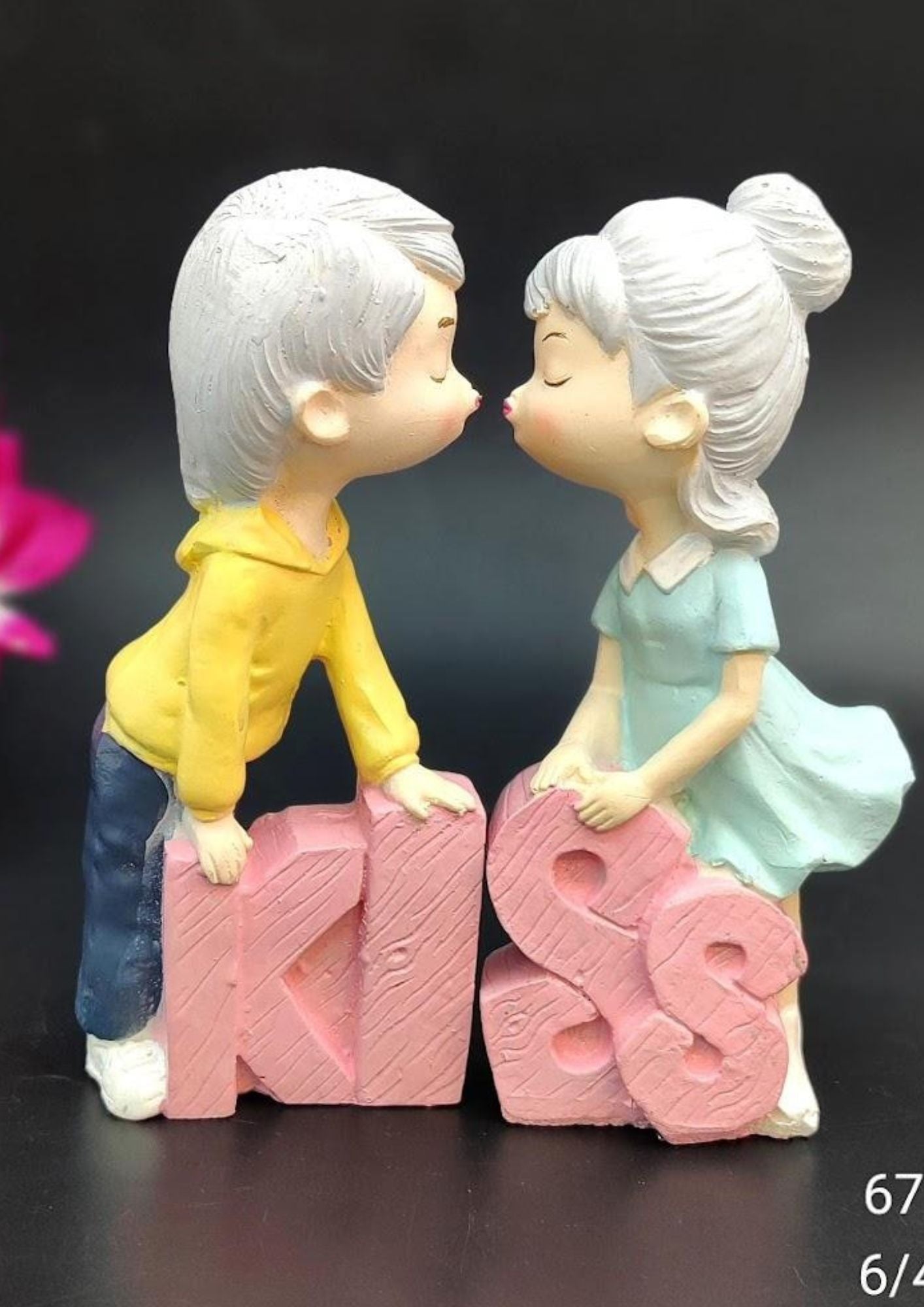 6-inch romantic couple figurine with a boy and girl leaning over pink ‘KISS’ text, crafted in resin, perfect for Valentine’s Day, anniversaries, or weddings.