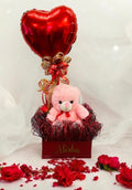 Teddy hamper featuring a plush teddy bear, heart-shaped balloon, and customized name gift box, ideal for romantic occasions and special celebrations.