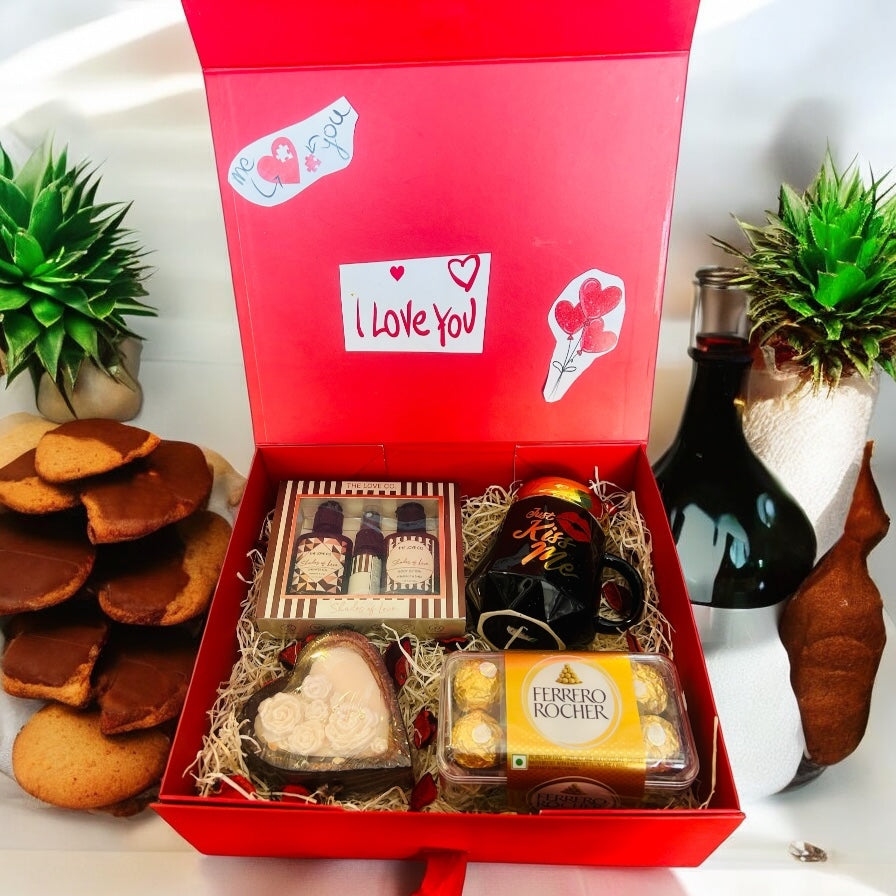 Luxury romance gift hamper with fragrance mist, shower gel, body lotion, Ferrero Rocher chocolates, coffee mug, and heart-shaped candle in a premium gift box.